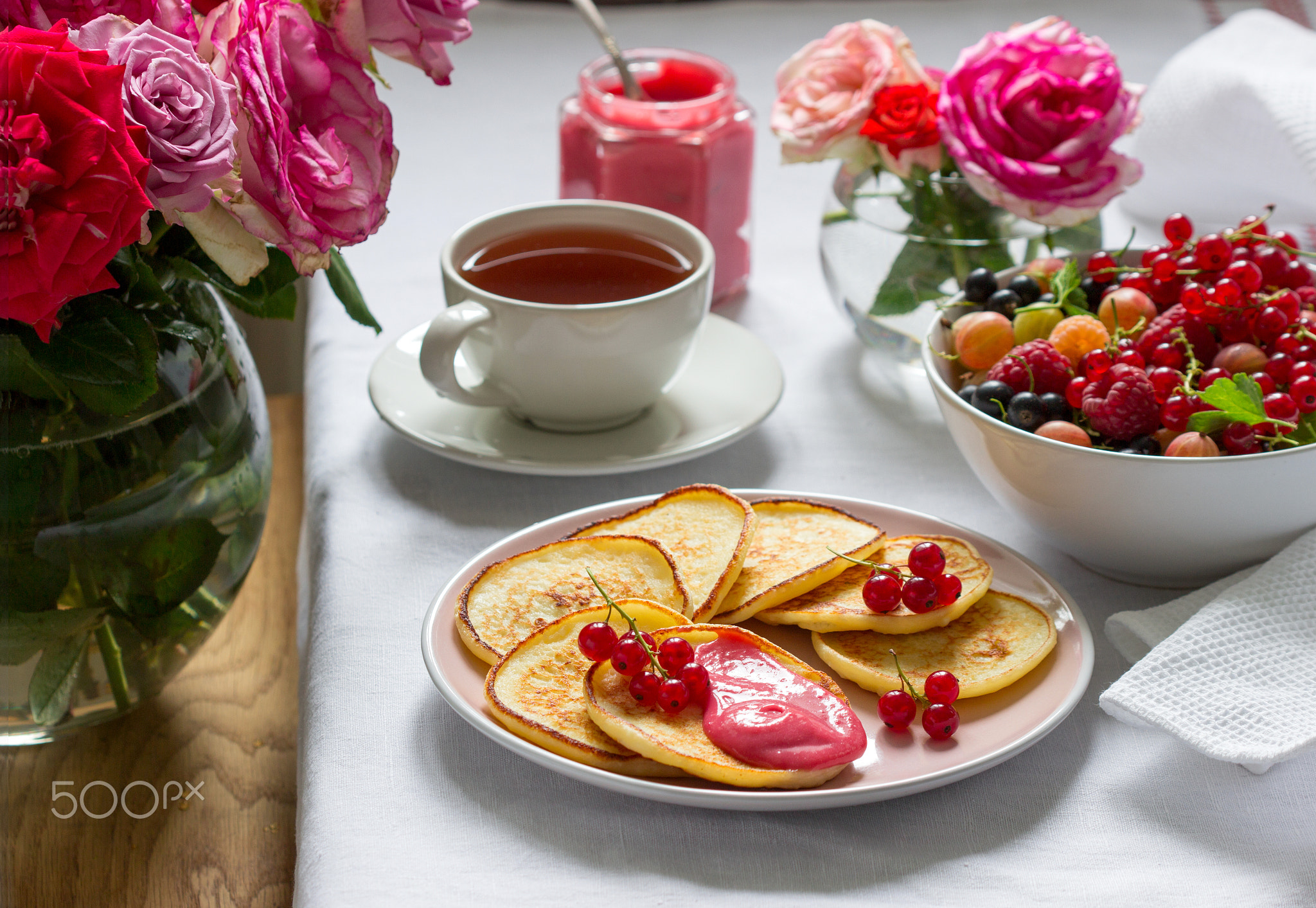 Curd pancakes with berry curd served with tea.