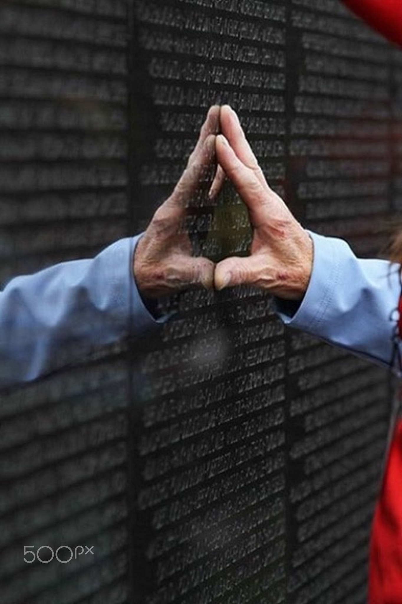 Ex Vietnam Soldier's hand on the Vietnam Veterans Memorial