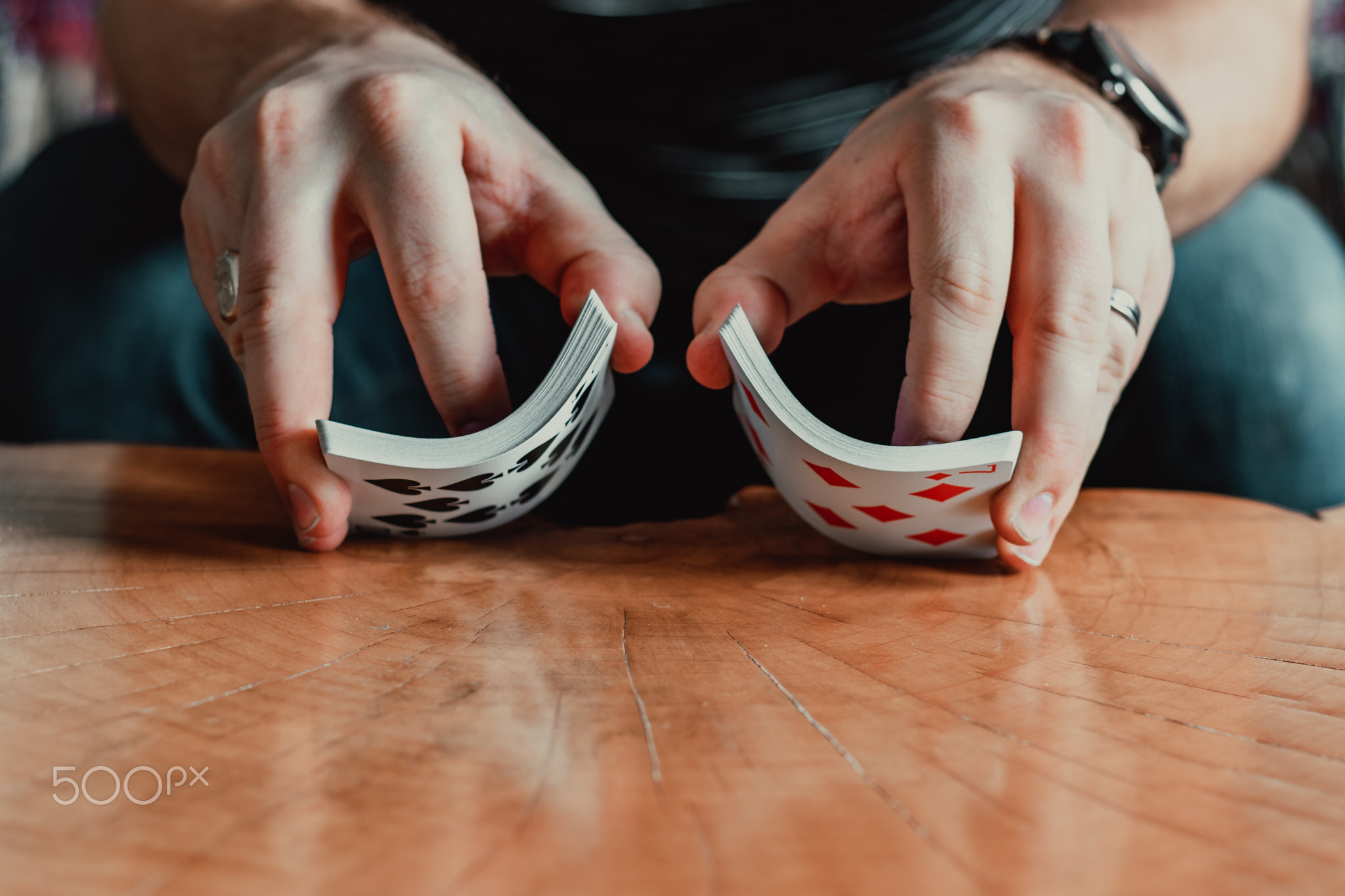 Hands holding playing cards