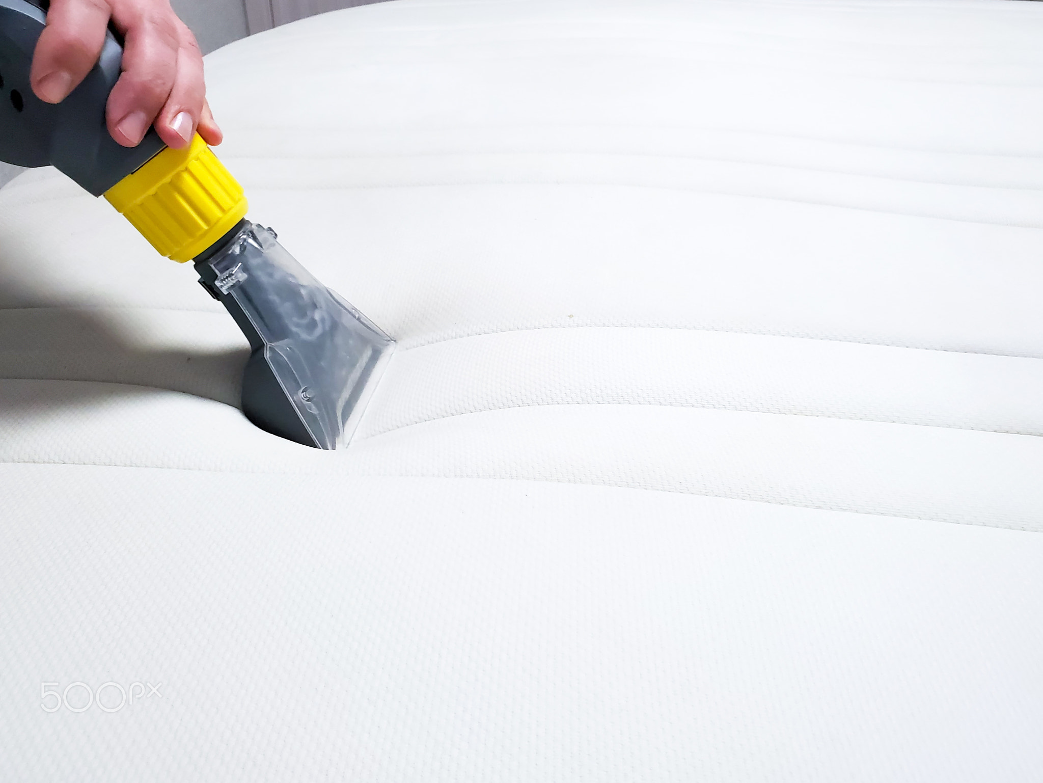 Mattress dry cleaning with professional extraction method. Close up