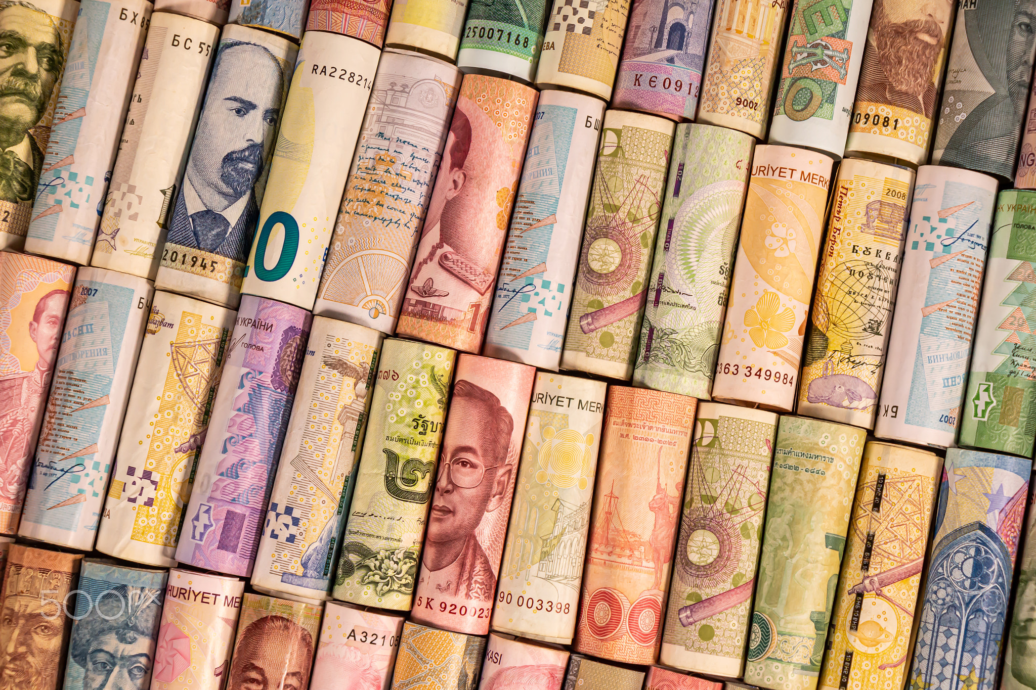 Different banknotes from various countries on rolls