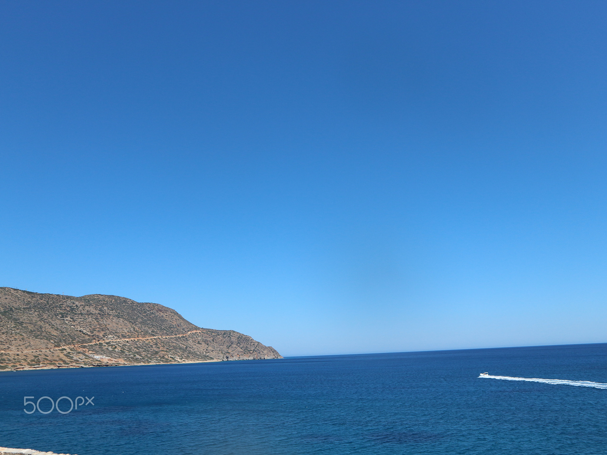 Jetski on the Open Ocean with Mountain and Path in View