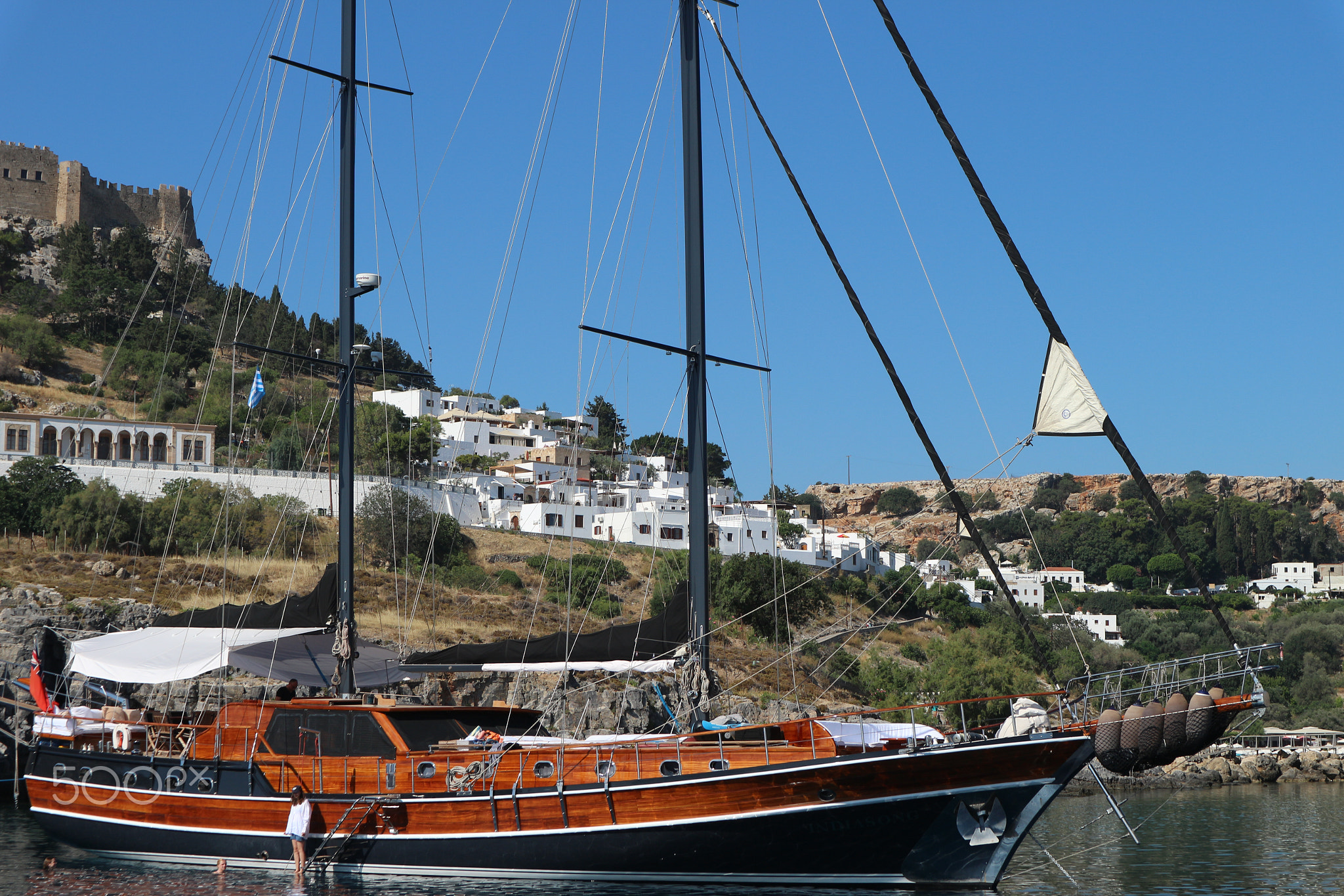 Brown and Black Sailboat Docked on Greeny Blue Ocean 