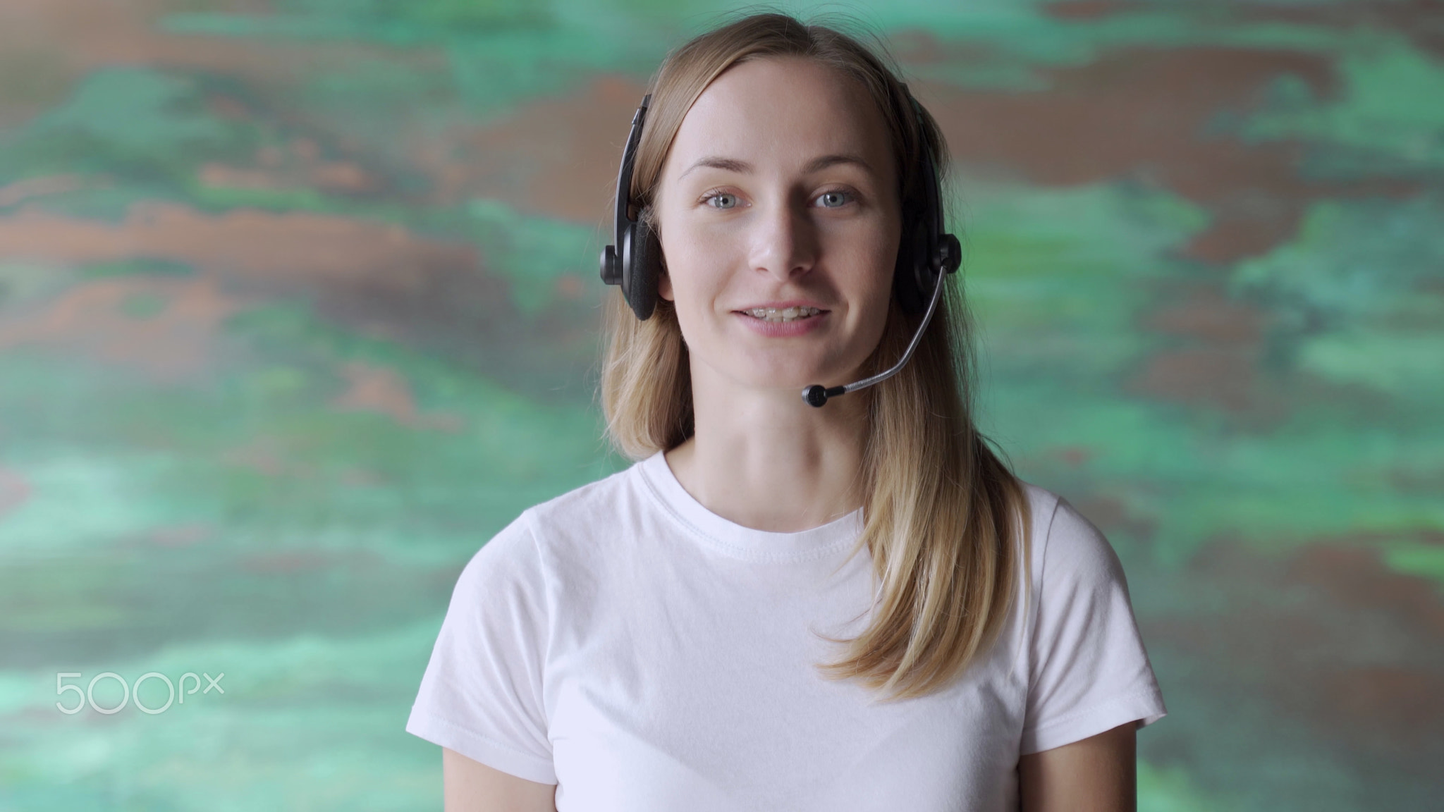 Business woman wears headset talks to web camera making distance