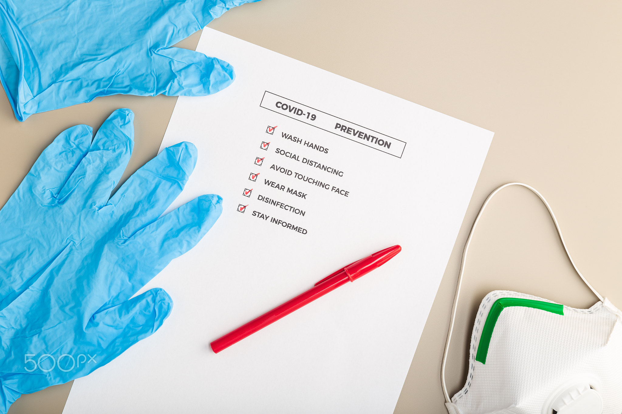 Desk with a COVID-19 prevention check list and safety equipment
