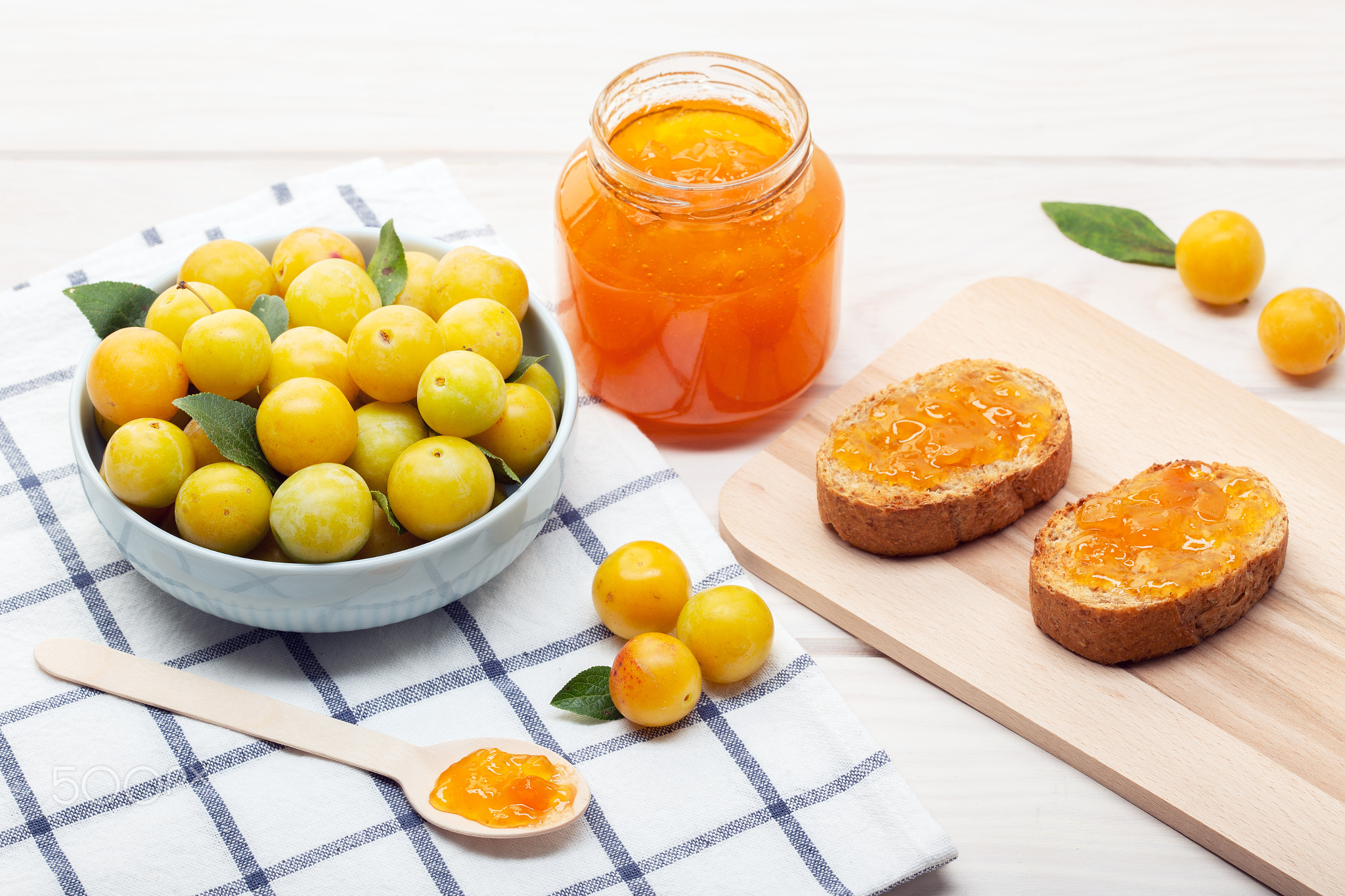 Pot of sweet jam, plum fruit and toasts