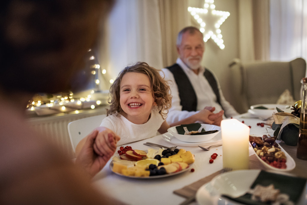 Small girl with grandparents sitting indoors celebrating Christmas by Jozef Polc on 500px.com