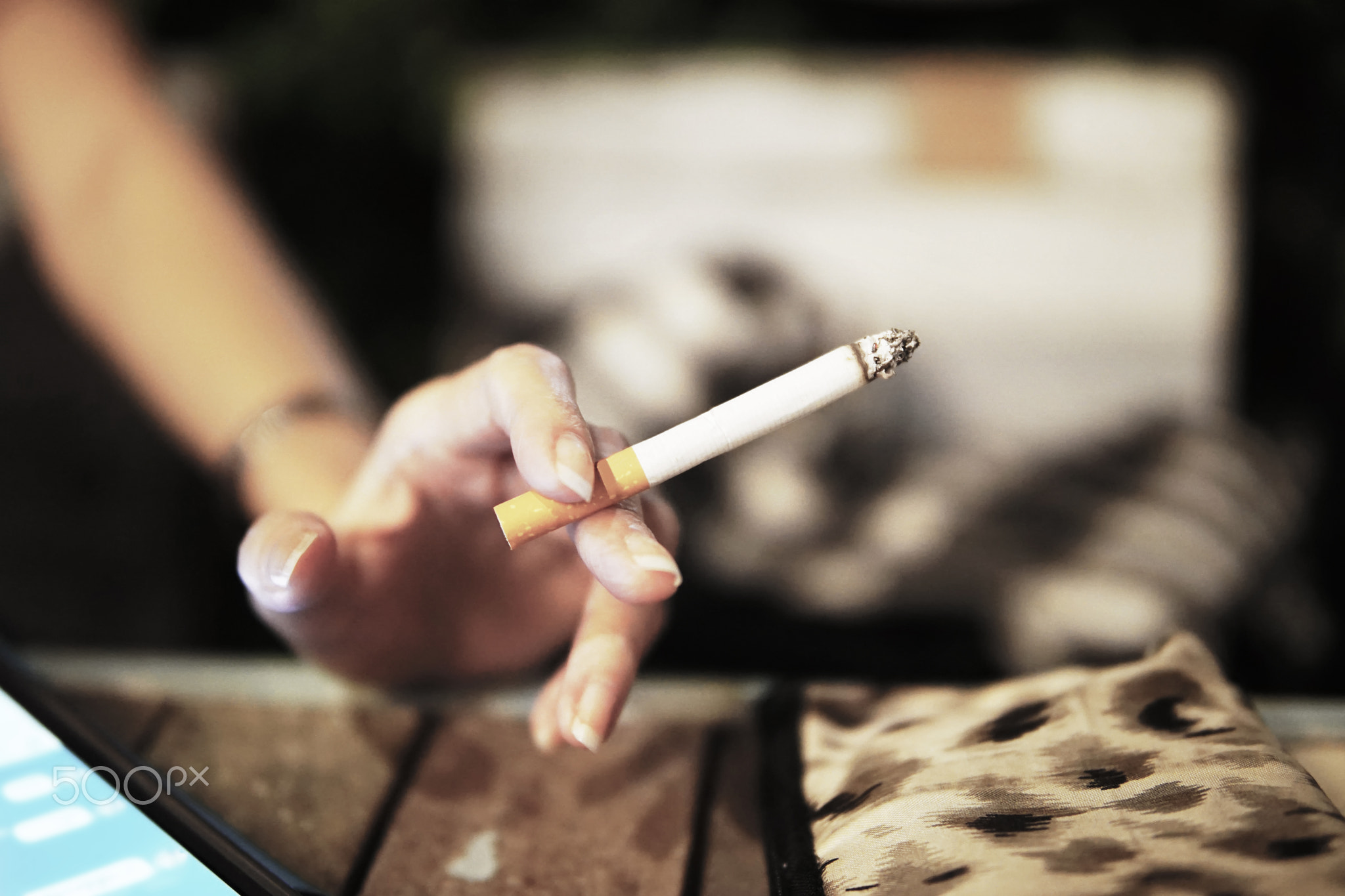 The cigarette in woman hand.