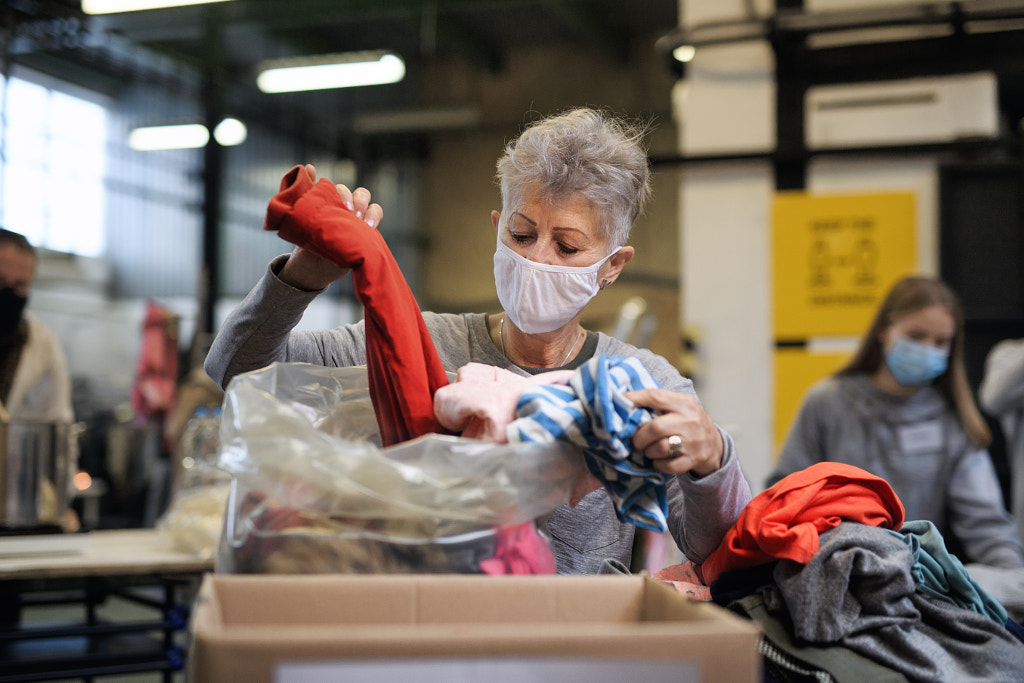 Volunteers working with food and clothes in community charity by Jozef Polc on 500px.com