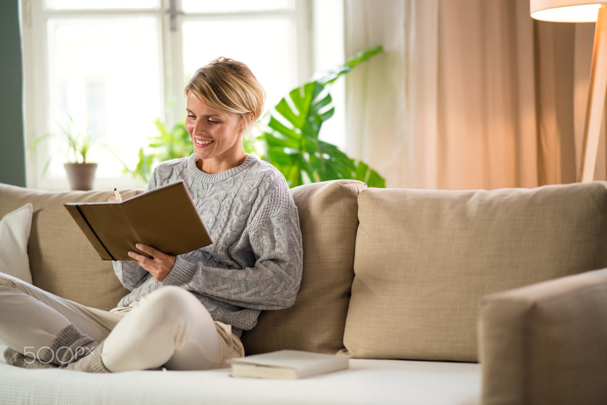 Portrait of woman relaxing indoors at home, mental health care concept