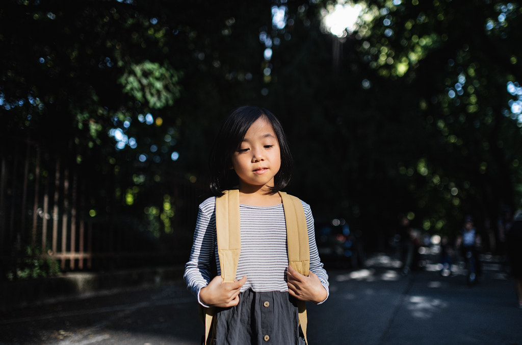 Portrait of small Japanese girl with backpack standing outdoors in by Jozef Polc on 500px.com