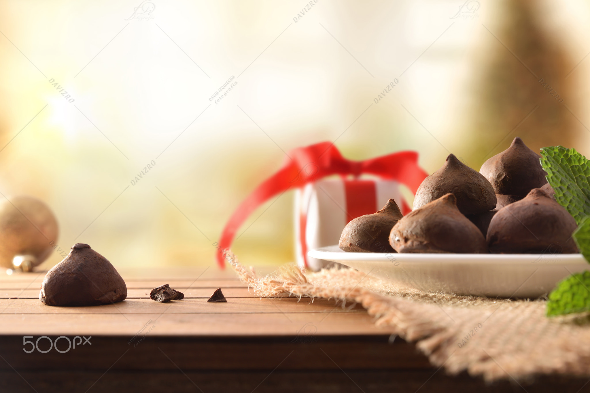 Chocolate truffles on plate on wooden table In Christmas front