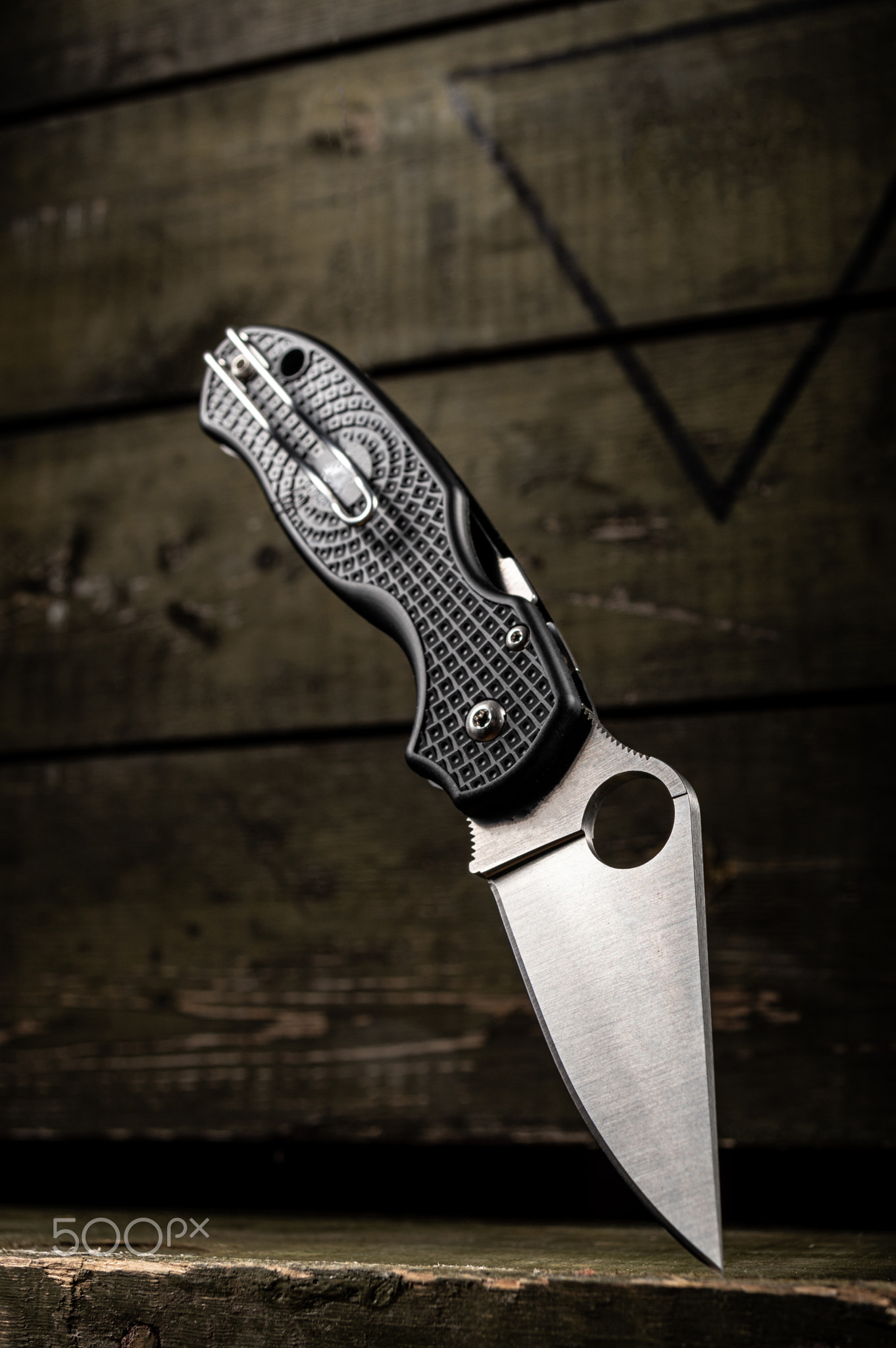 Knife with a hole in the blade. Wire clip for carrying knife.
