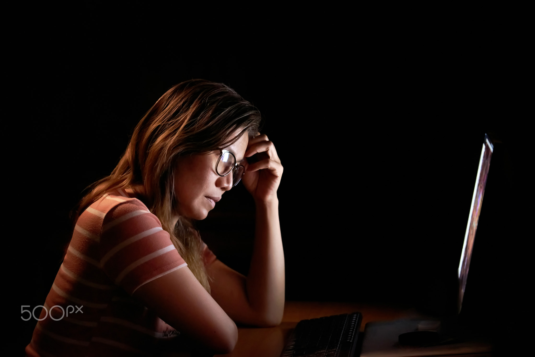 Serious woman in the front of the monitor