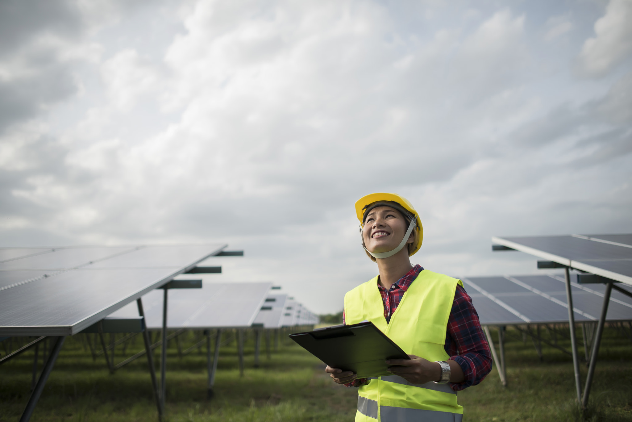 Engineer electric woman checking and maintenance of solar cells.