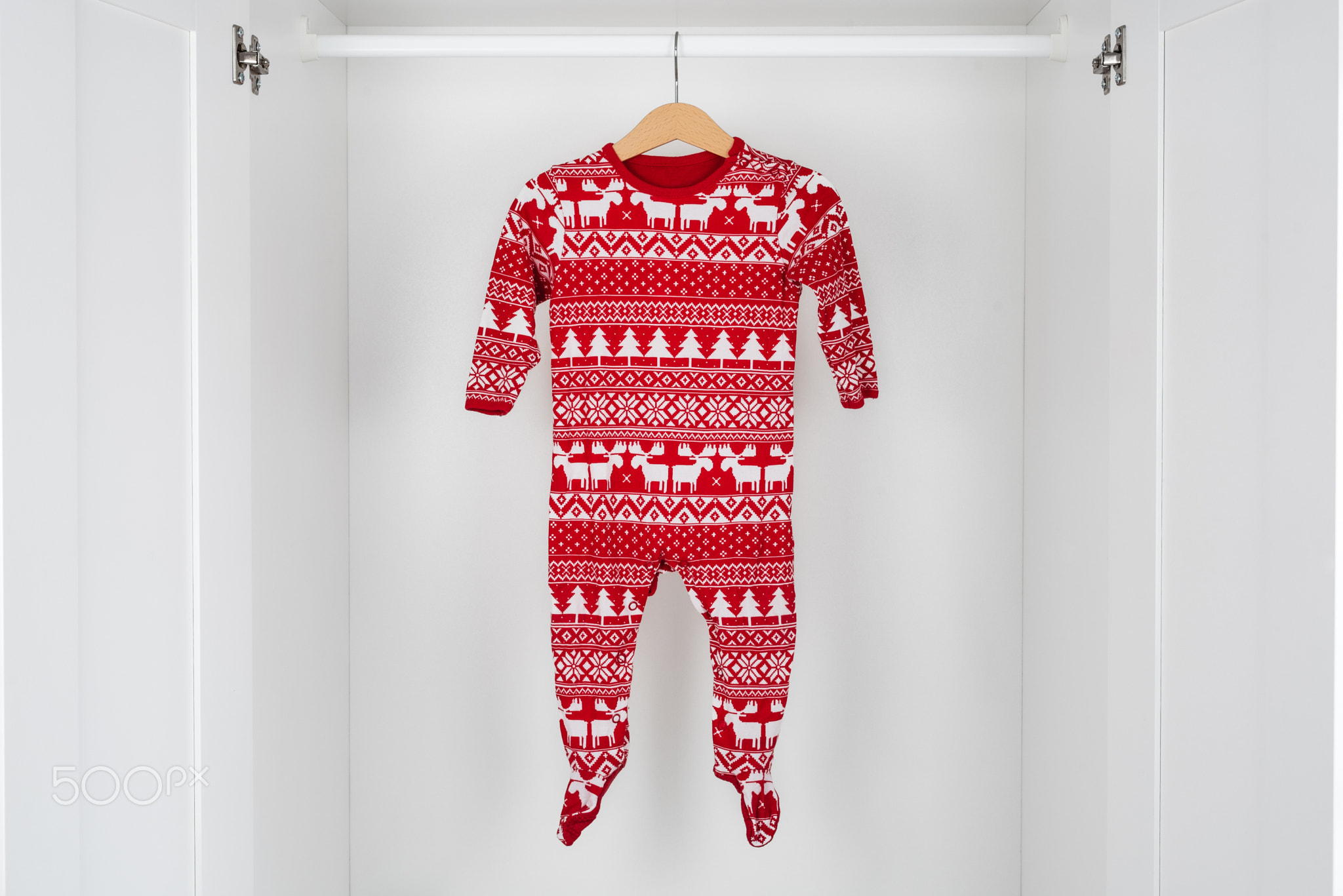 White and red christmas pajamas in a white closet.
