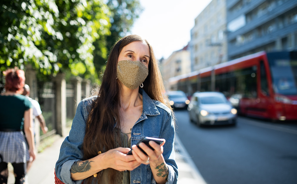 Mature woman with smartphone outdoors in city or town park, walking by Jozef Polc on 500px.com