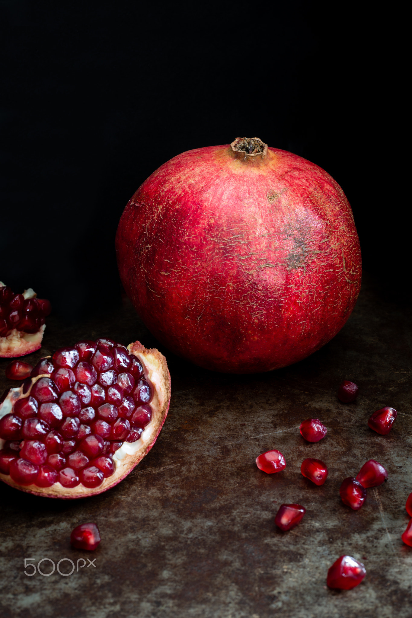 Still life with pomegranates on a black background