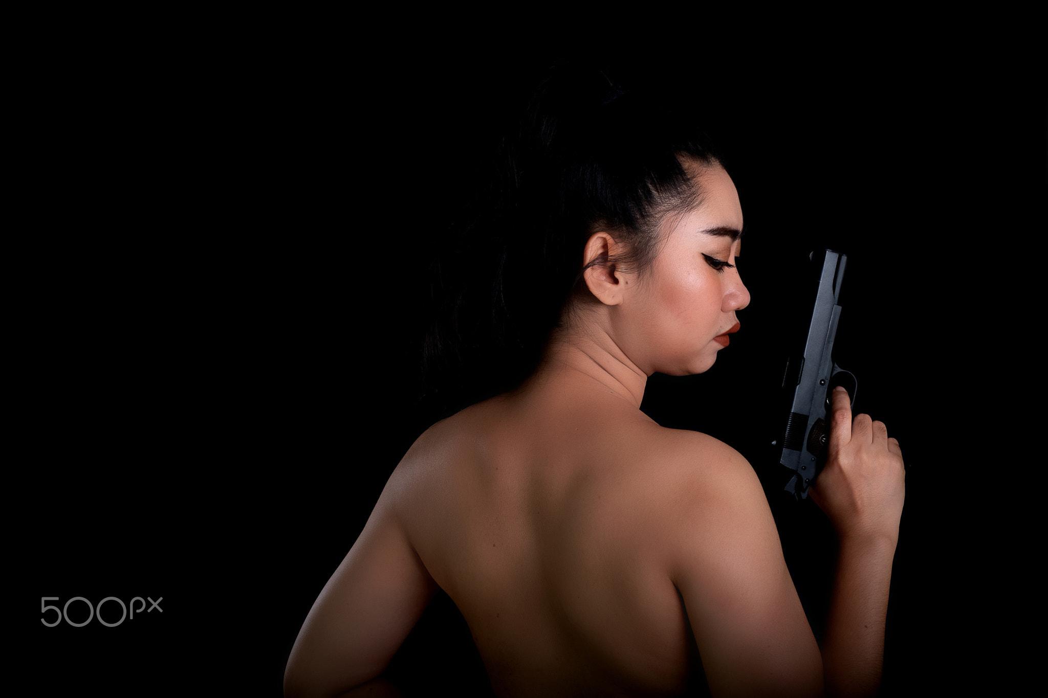 Asia woman one hand holding a gun