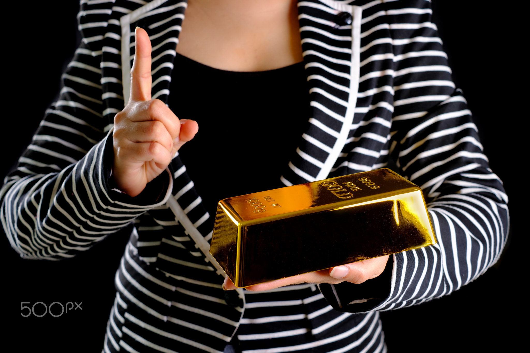 Business woman holding the gold bar