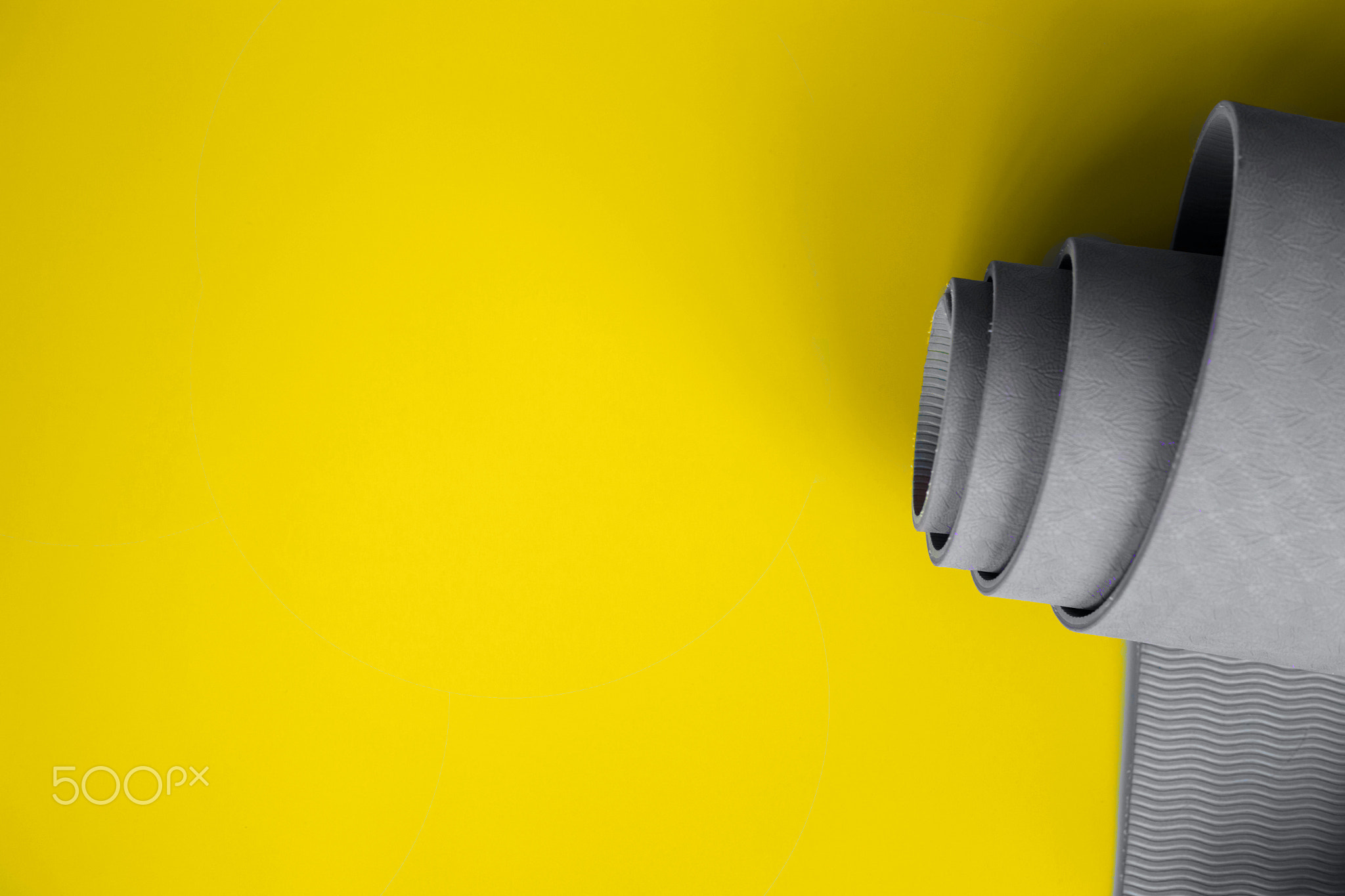 Ultimate gray yoga mat on a illuminating background