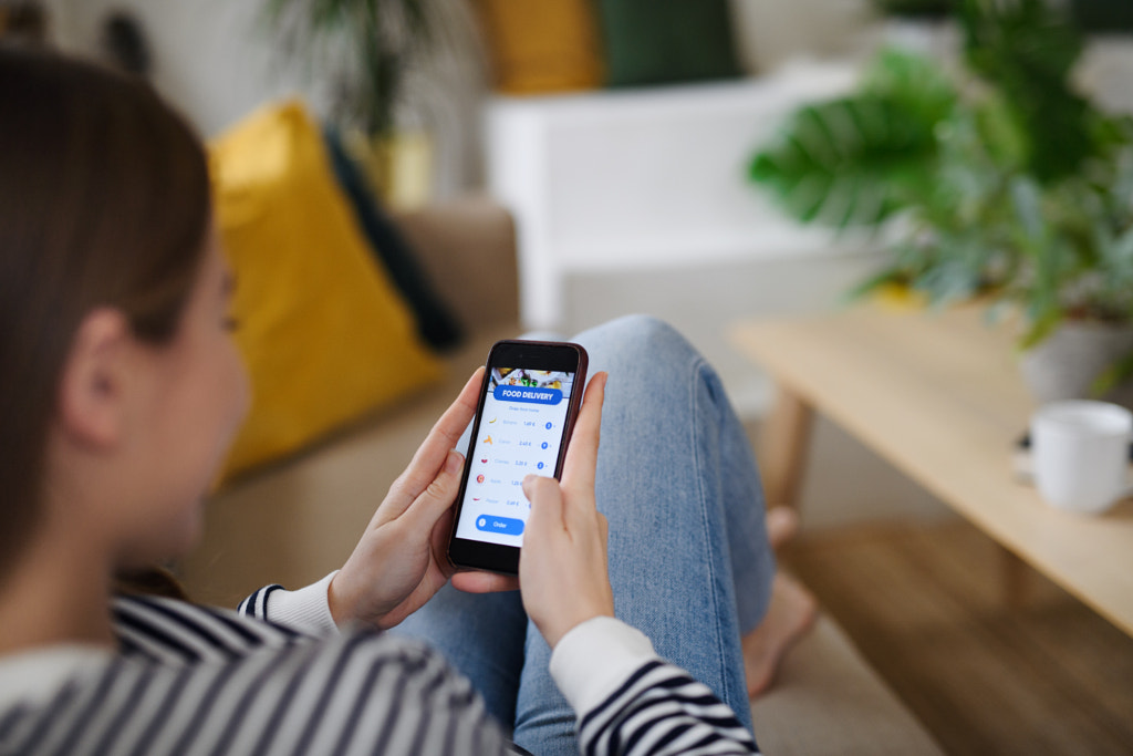 Young woman with smartphone ordering food at home, coronavirus and by Jozef Polc on 500px.com