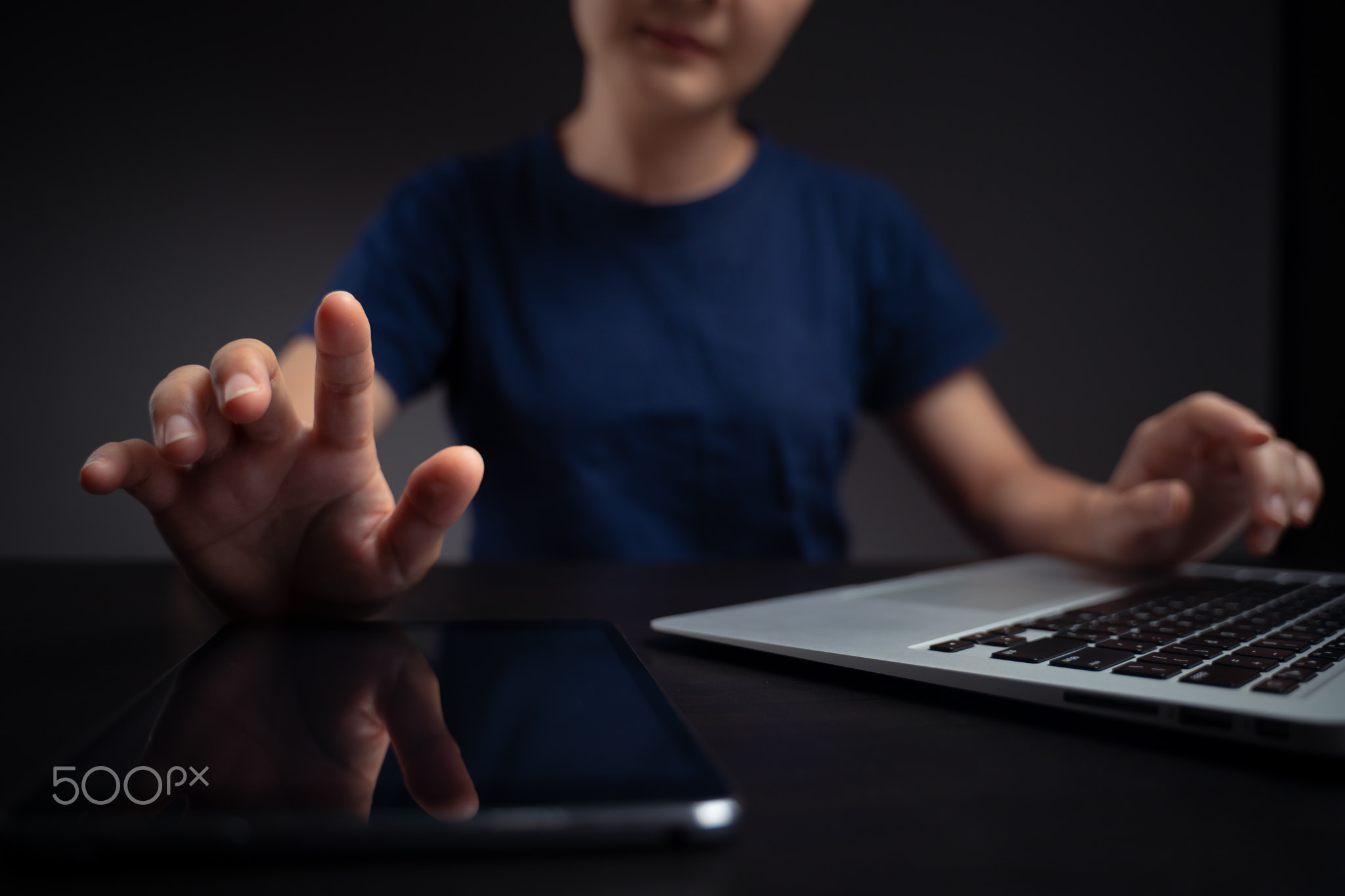 Hands and tablet working with laptop.