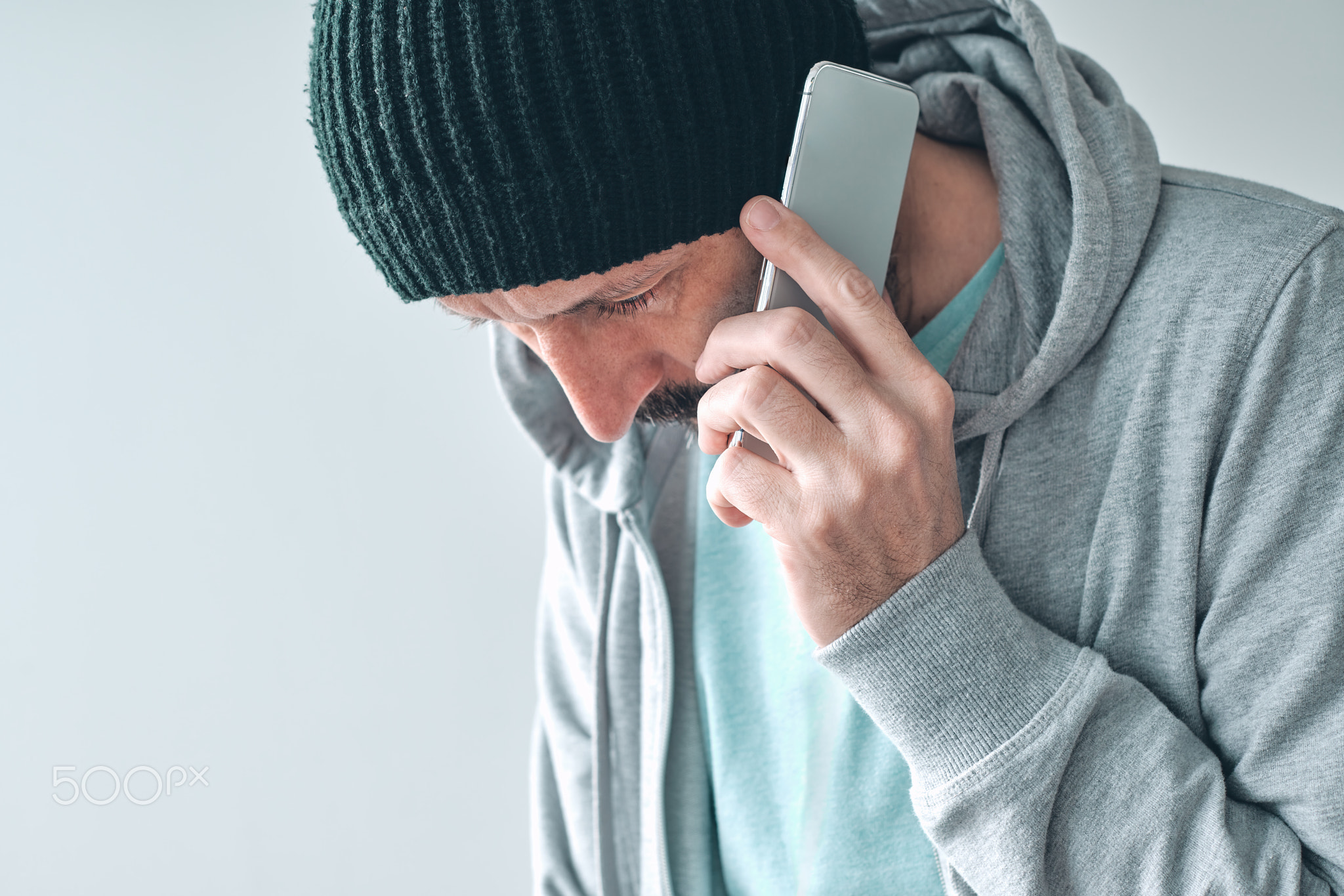 Unhappy man receiving bad news phone call