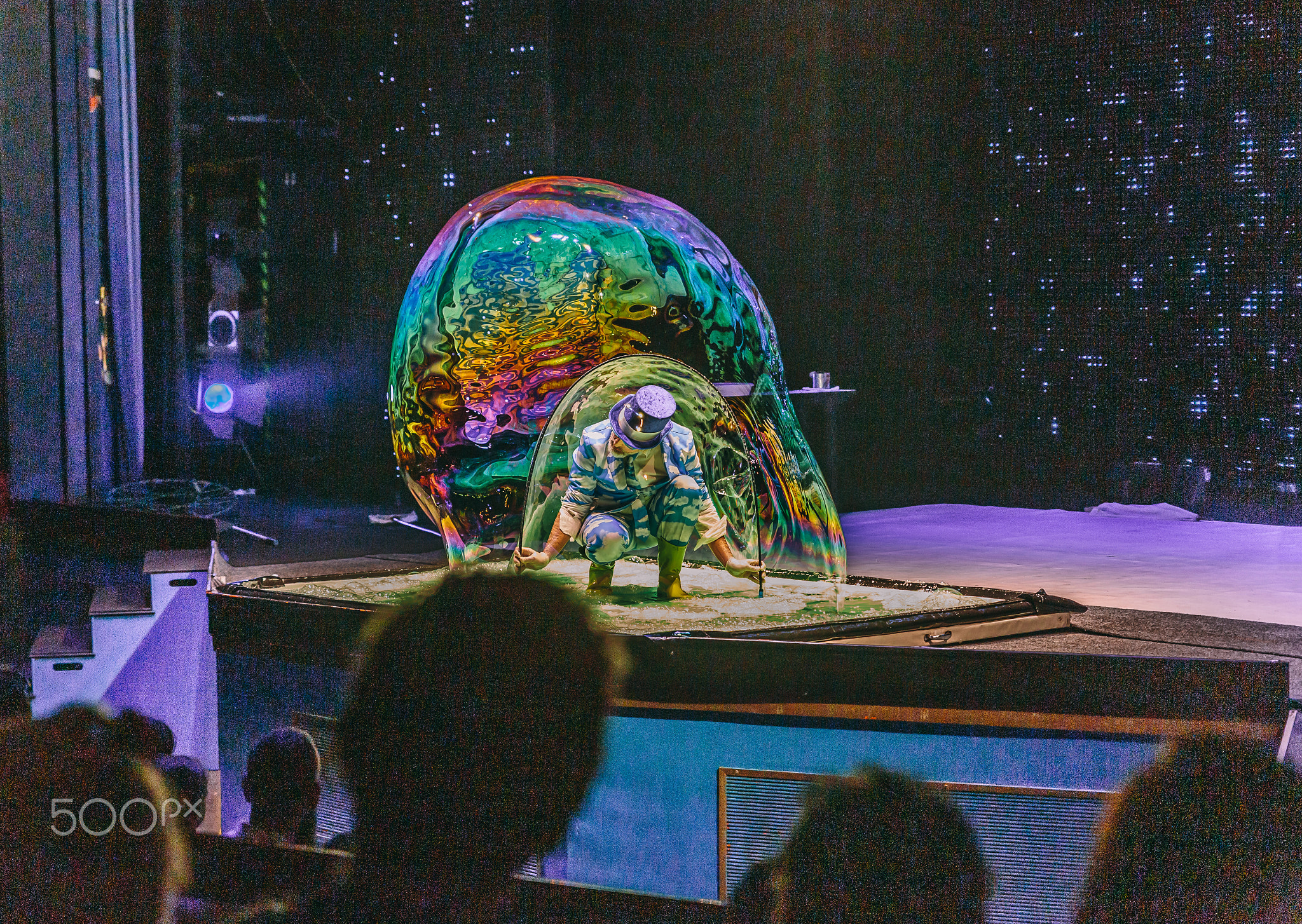 Show man blowing giant soap bubbles