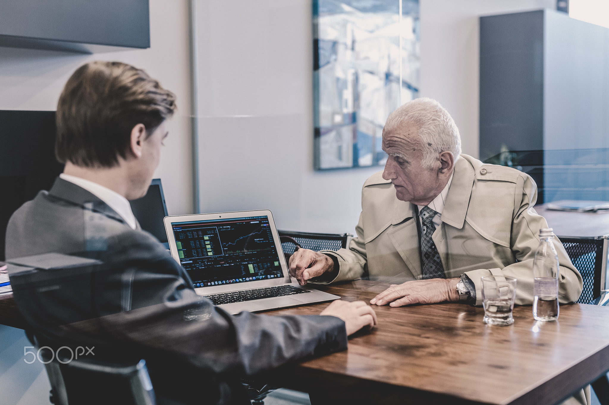 Financial advisor consulting senior client with his investment