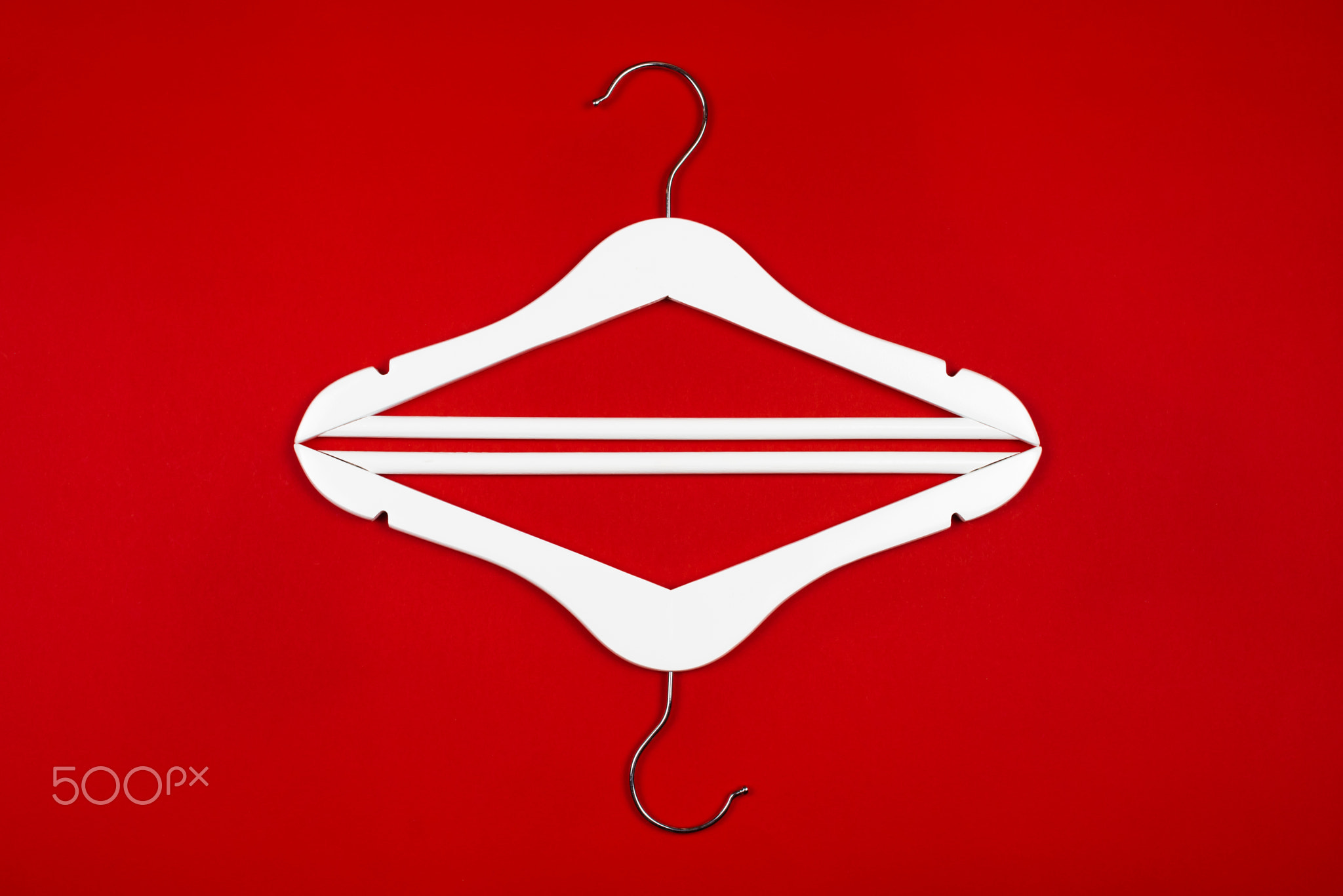 White hangers on a red background. Sales clothes concept.
