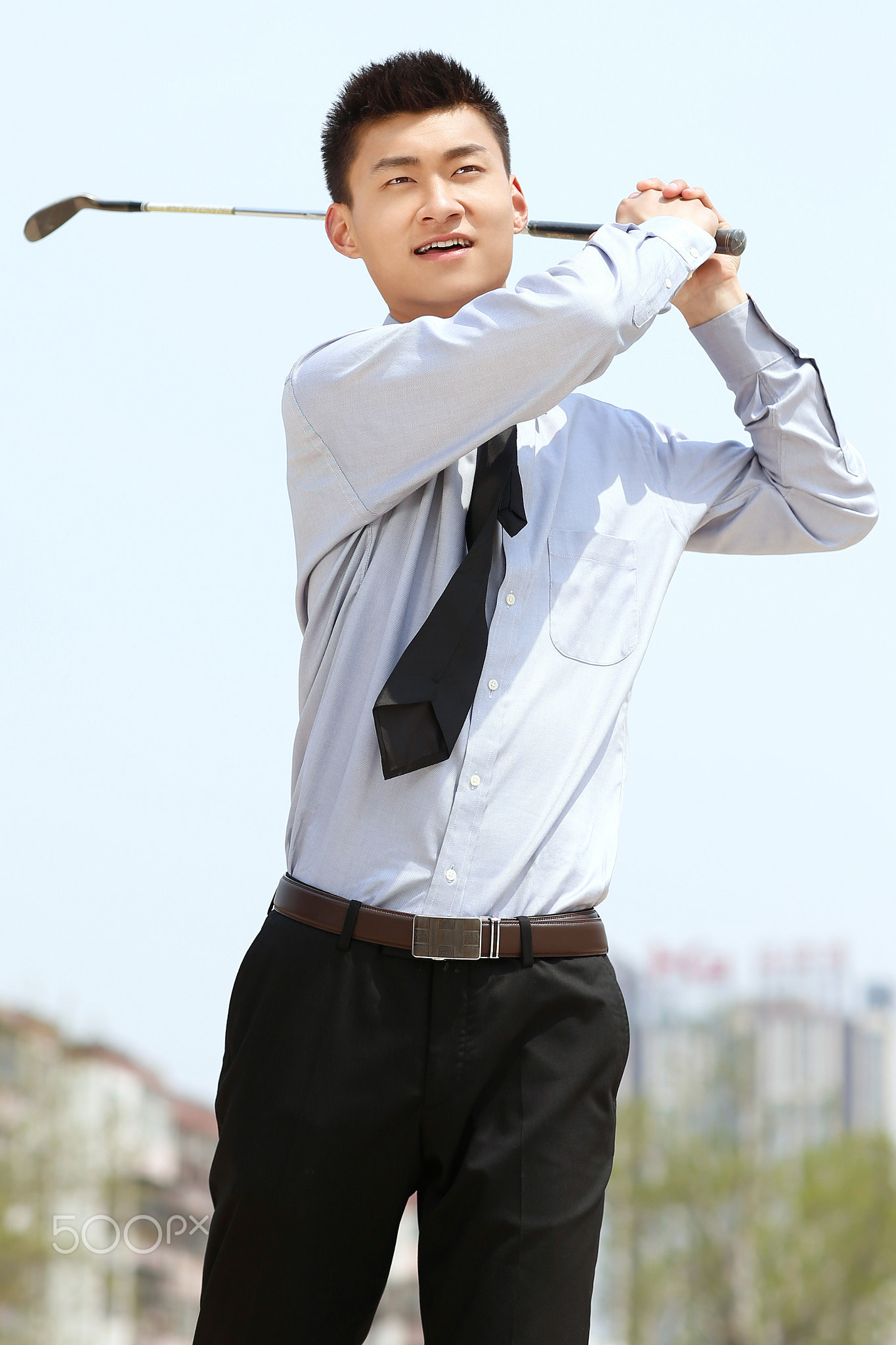 The business man playing golf in the park