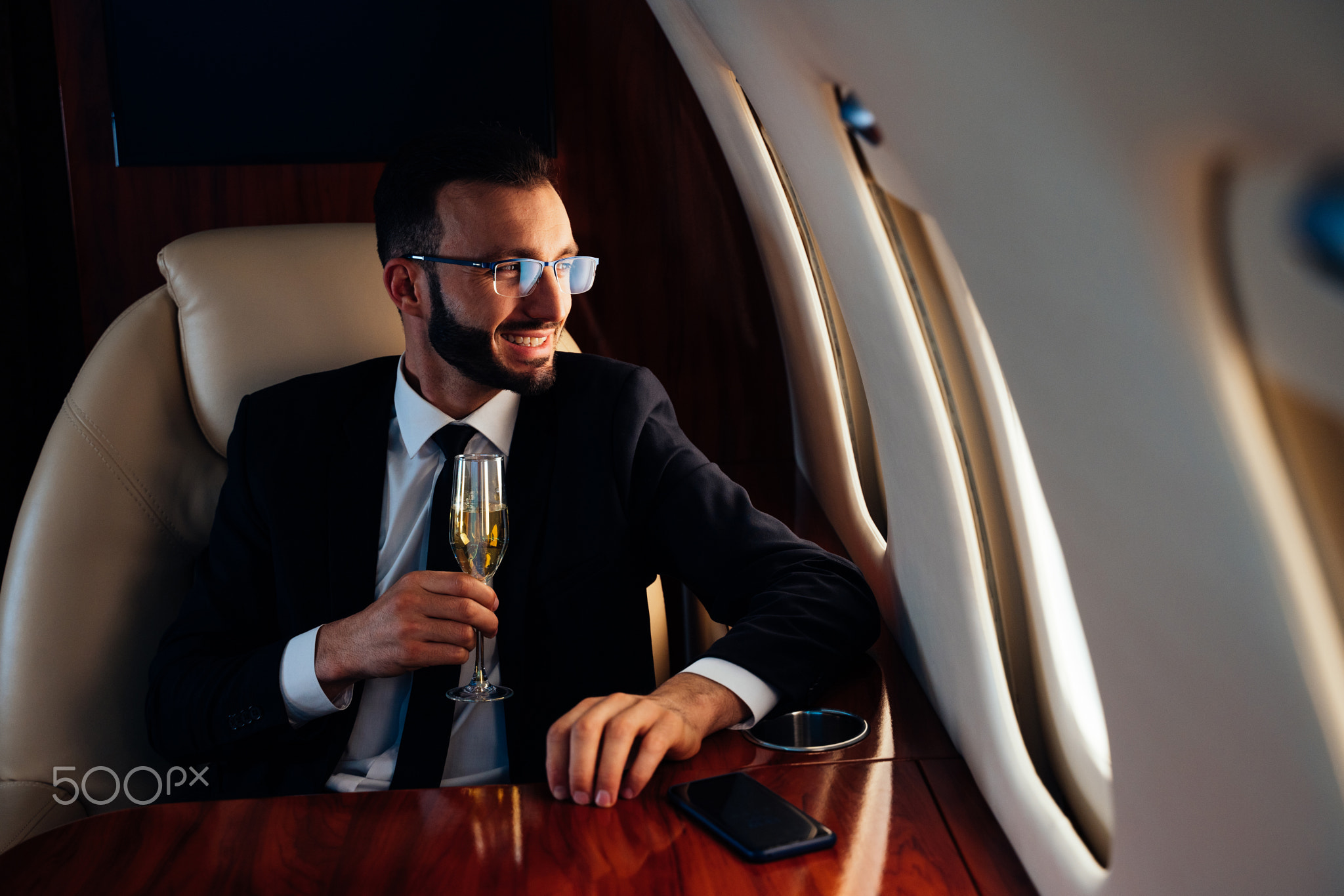 Businessman flying on his private jet.