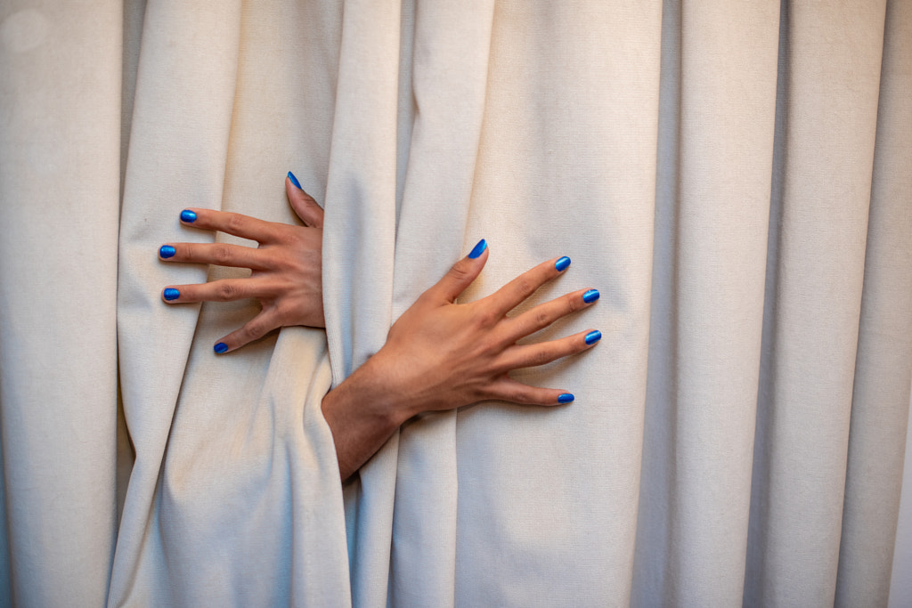 Close up shot of hands protruding from behind curtain by Rushay Booysen on 500px.com