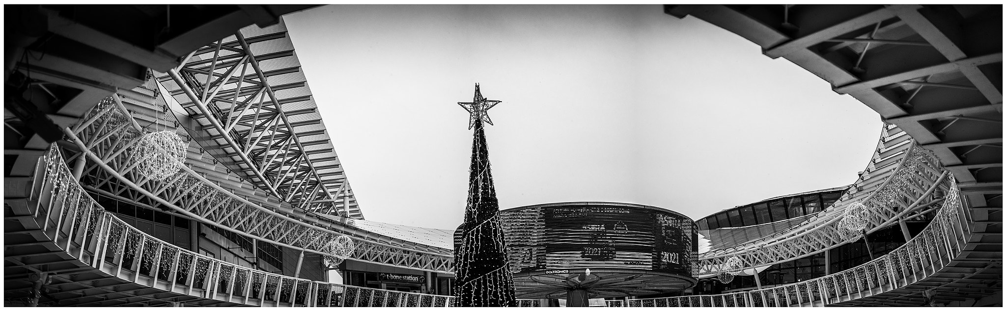 panoramic shot modern mall in black and white during christmas