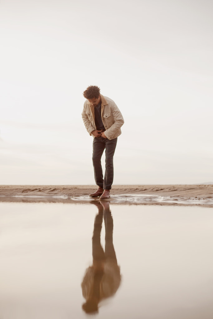 Portrait of young biracial man looking at his reflection by Anna Neubauer on 500px.com