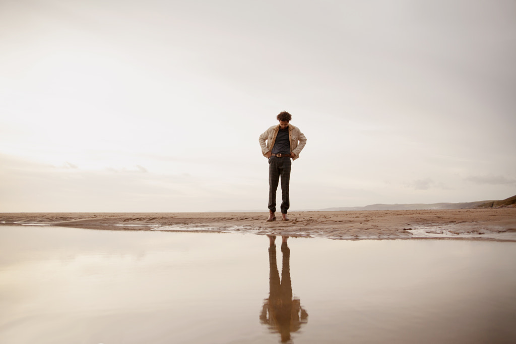 Portrait of young biracial man looking at his reflection by Anna Neubauer on 500px.com