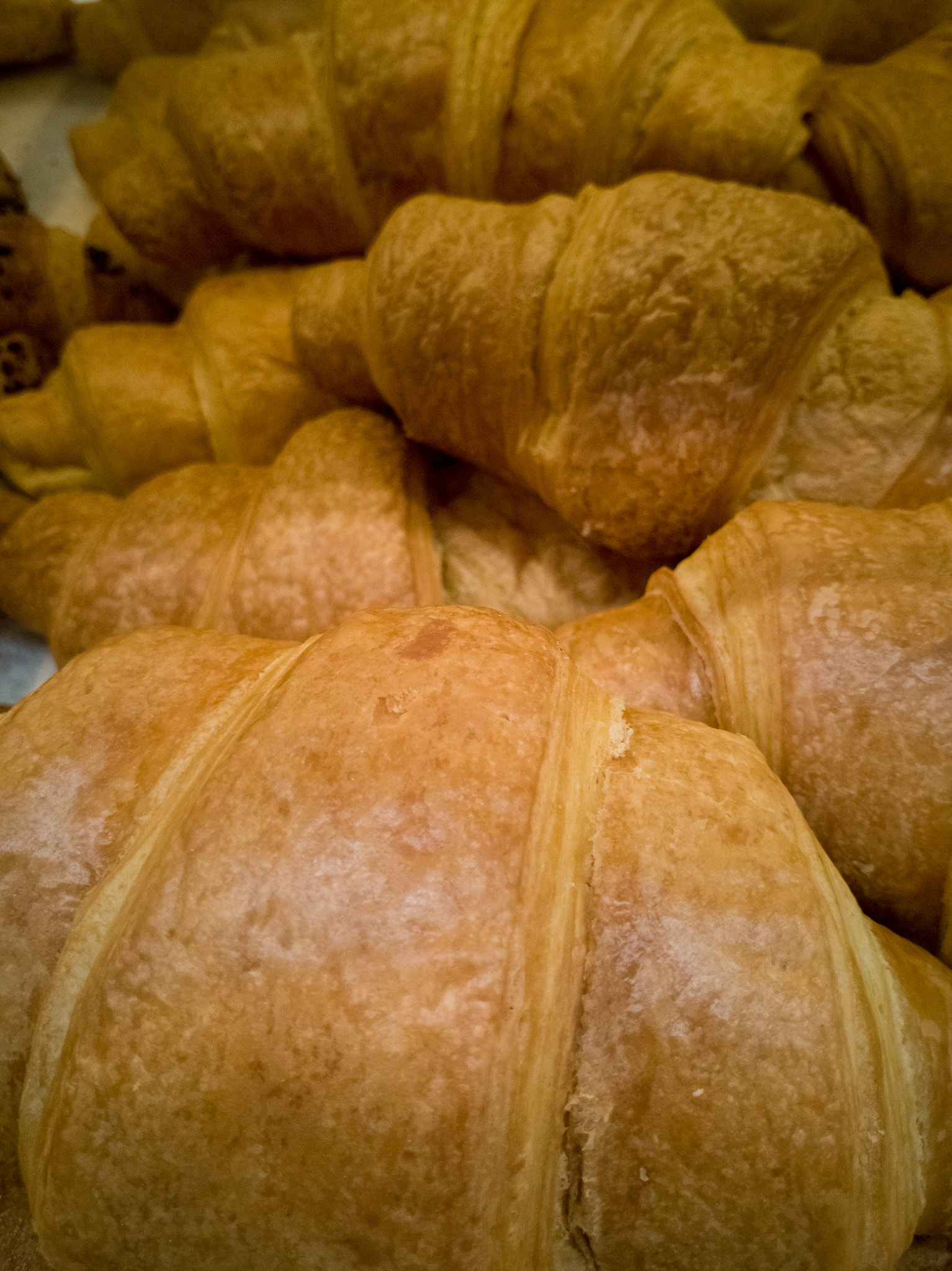 Golden delicious croissant in a bunch of a few pieces close-up