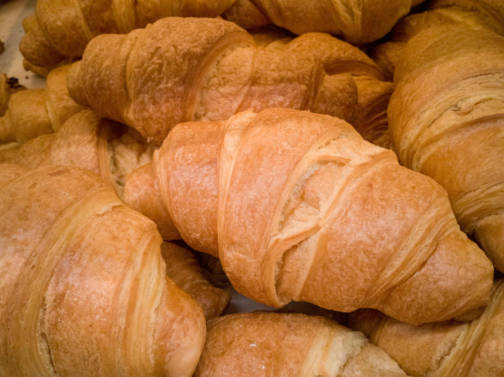 Golden delicious croissant in a bunch of a few pieces close-up