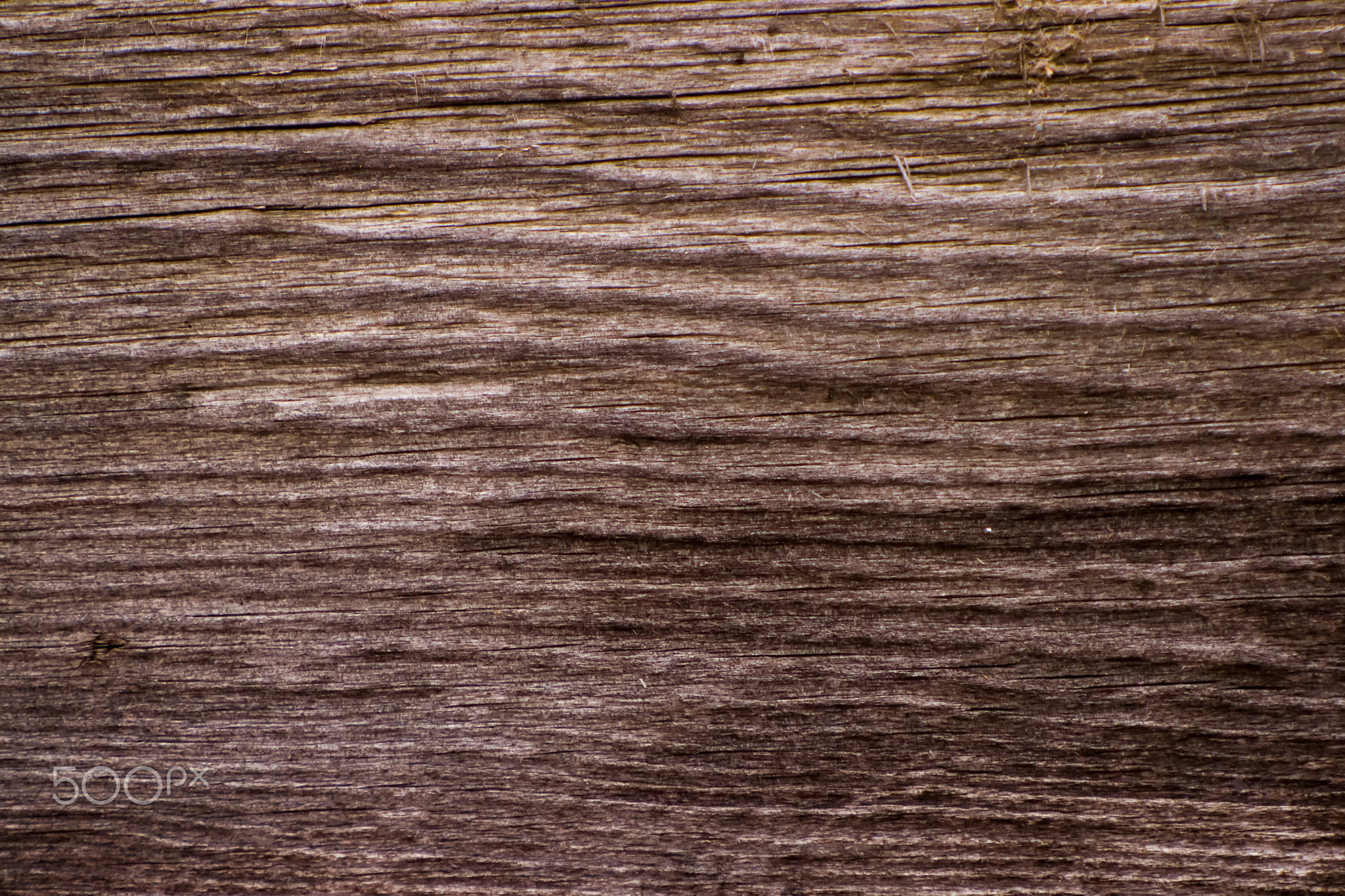 The texture of the old coniferous wood planks darkened with age.