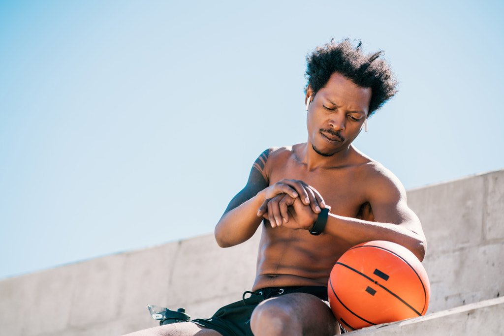 Fitness man checking time on smart watch. by Mego Studio on 500px.com