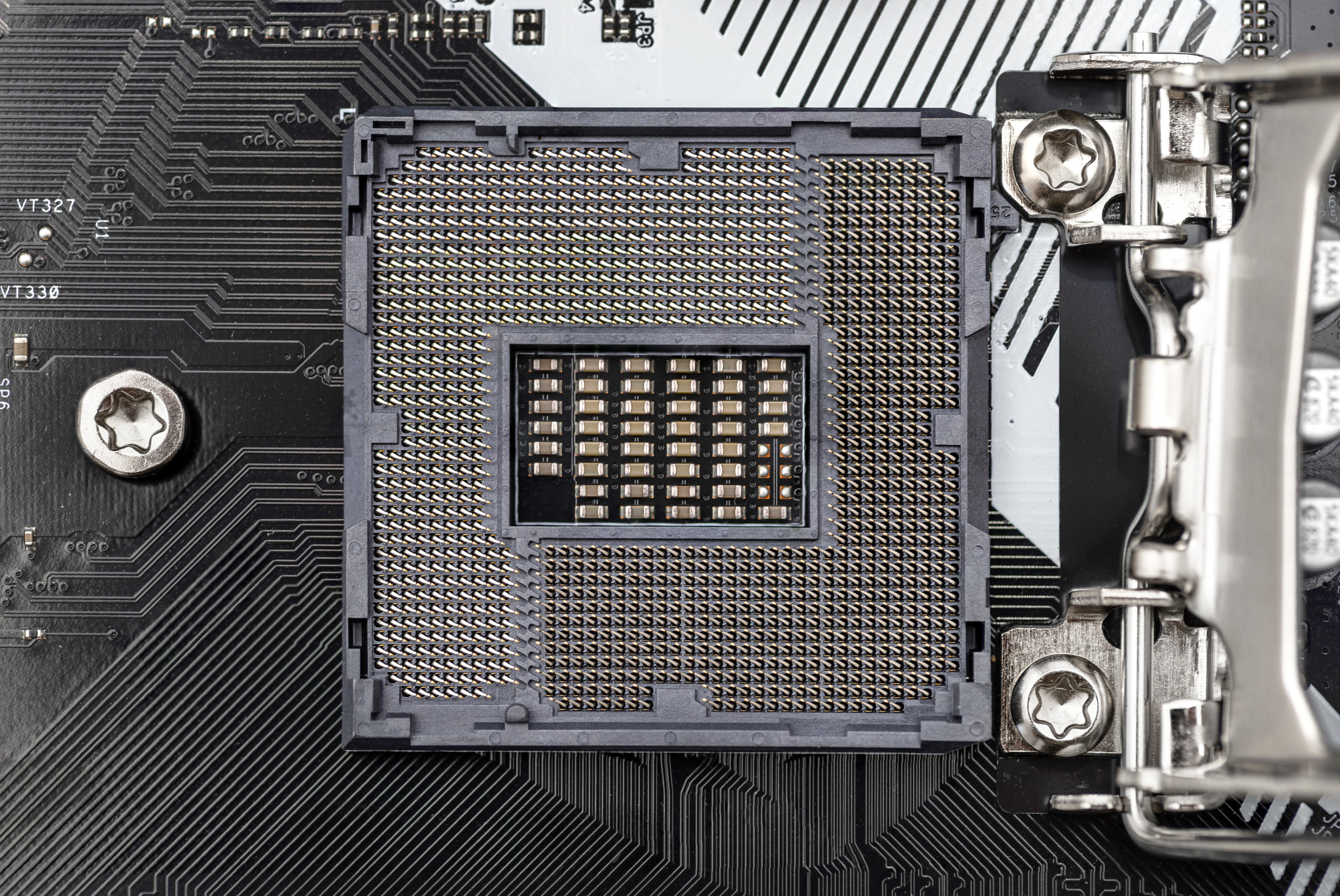 Top macro shot of empty modern LGA 1200 socket for CPU on black.