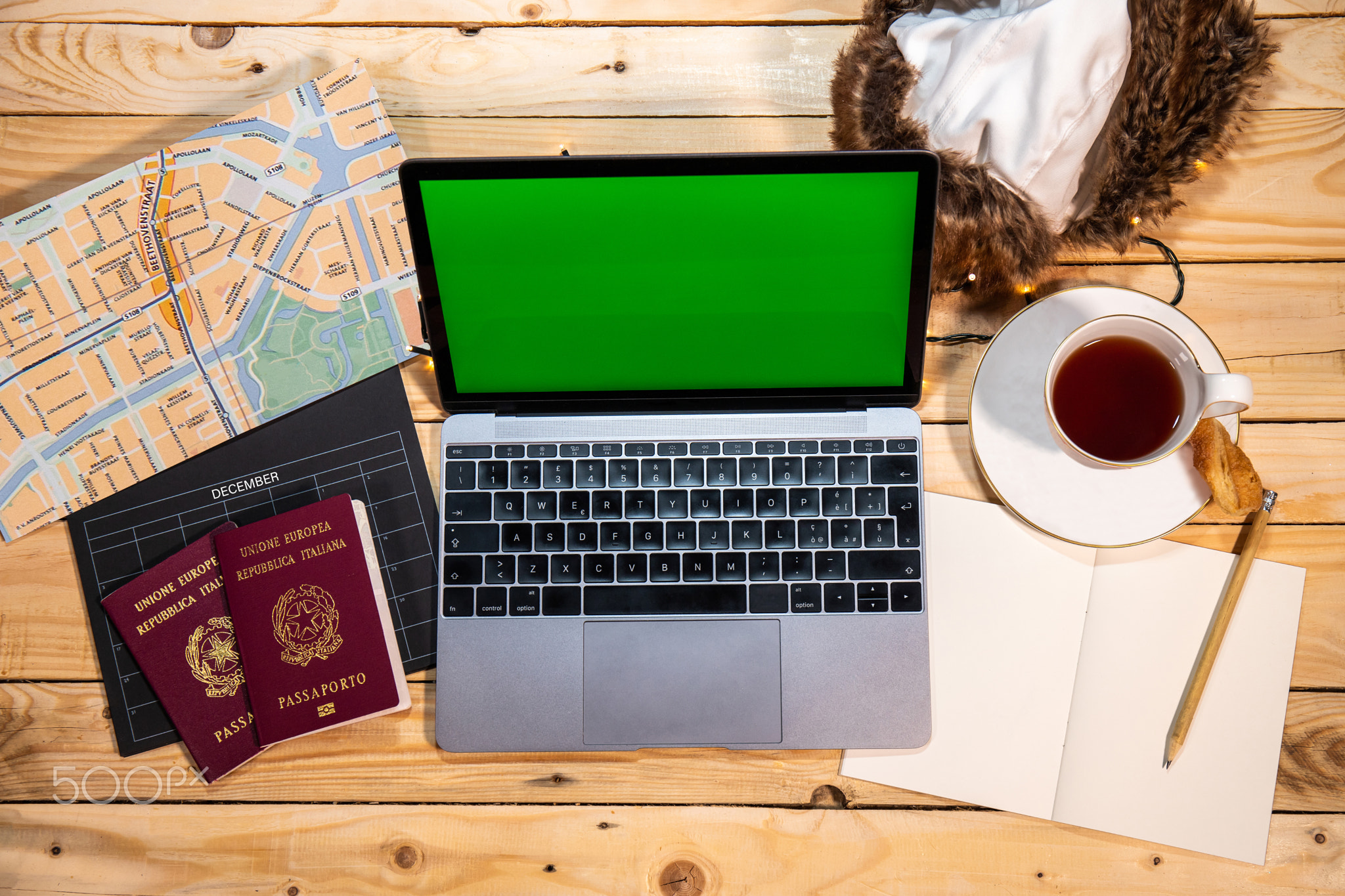 Organize a new trip with map, computer and passports.