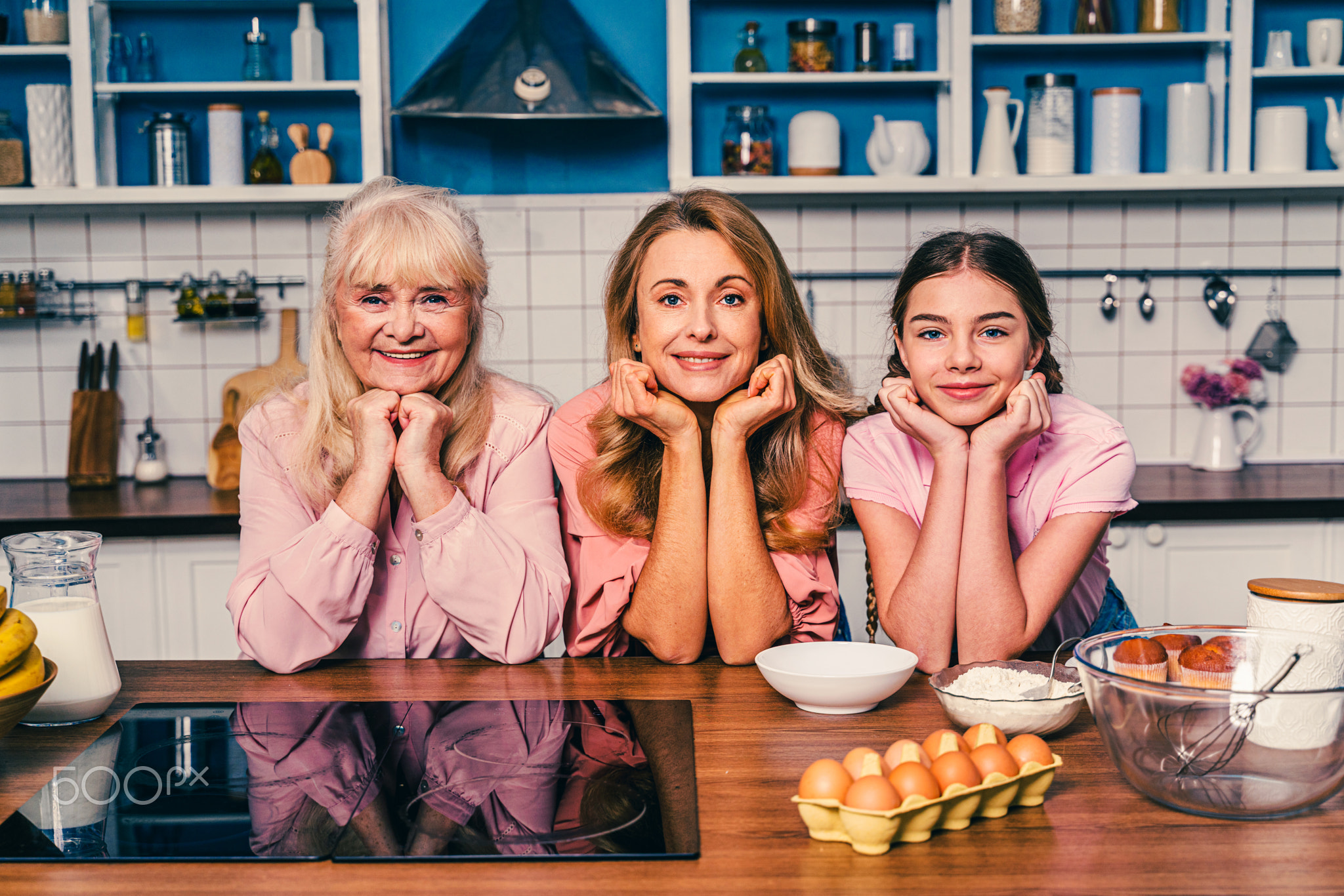 Beautiful senior woman and her family baking in the kitchen