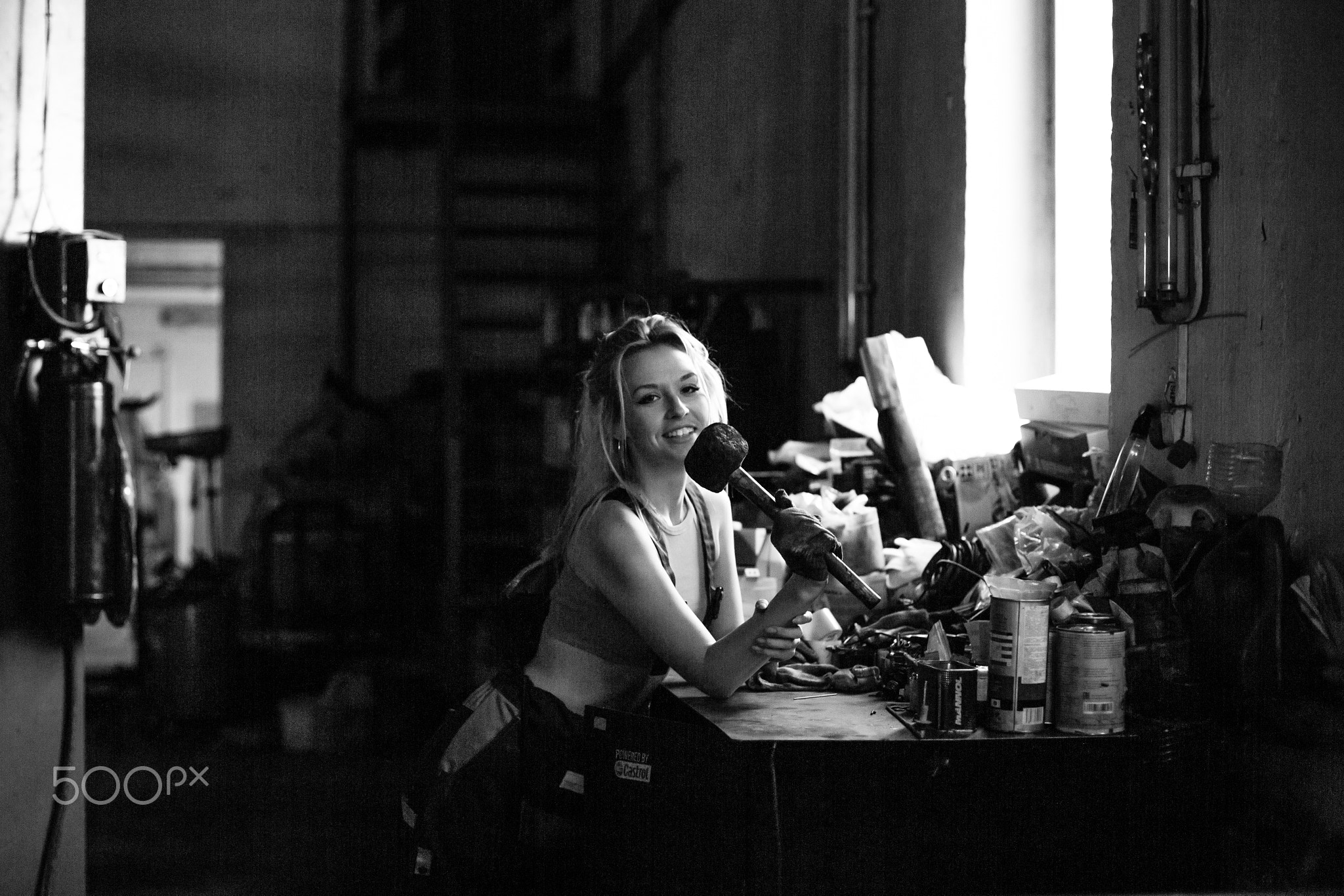 Sexual girl wearing dirty clothes posing in the workshop