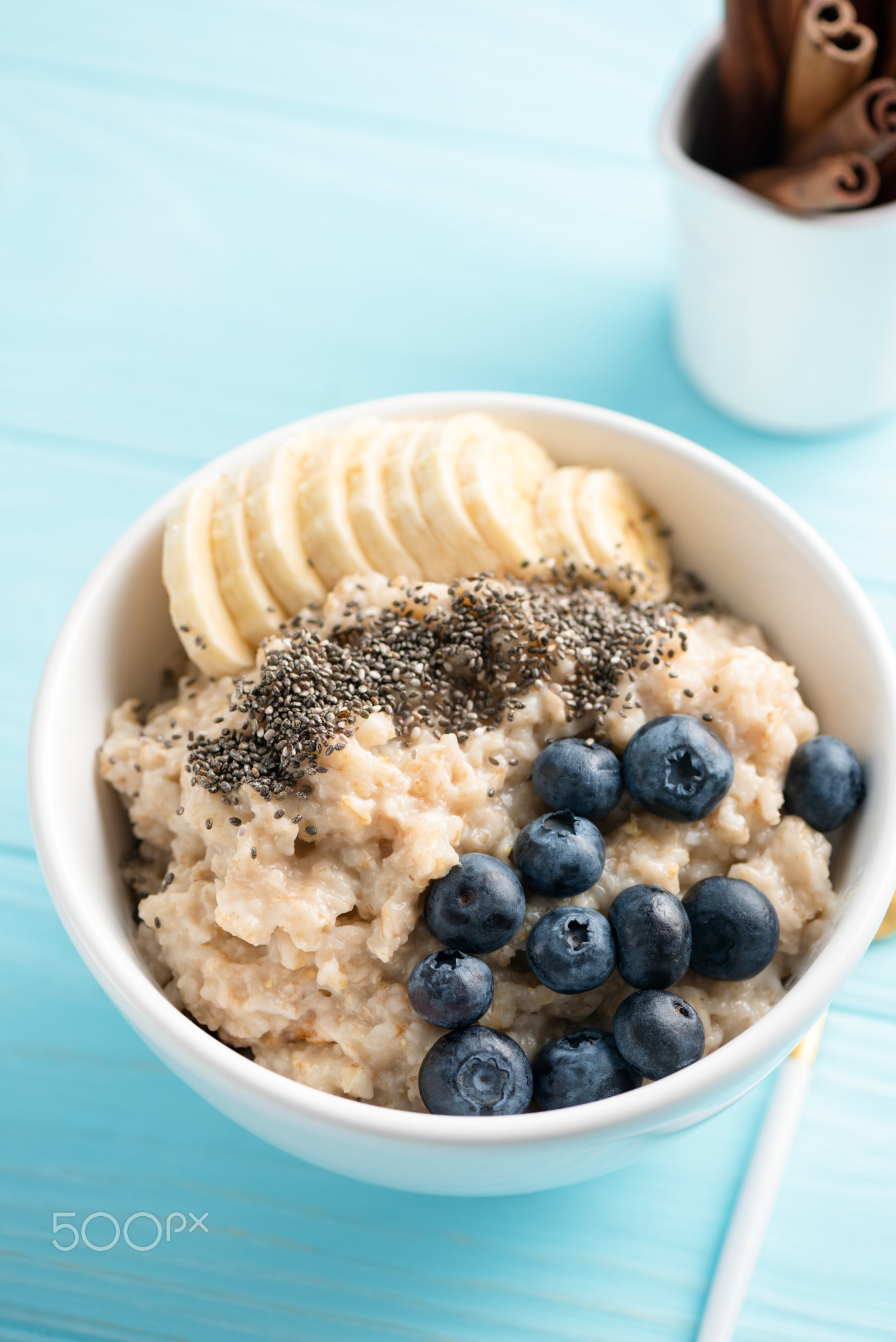 Oatmeal porridge with banana slices and blueberries