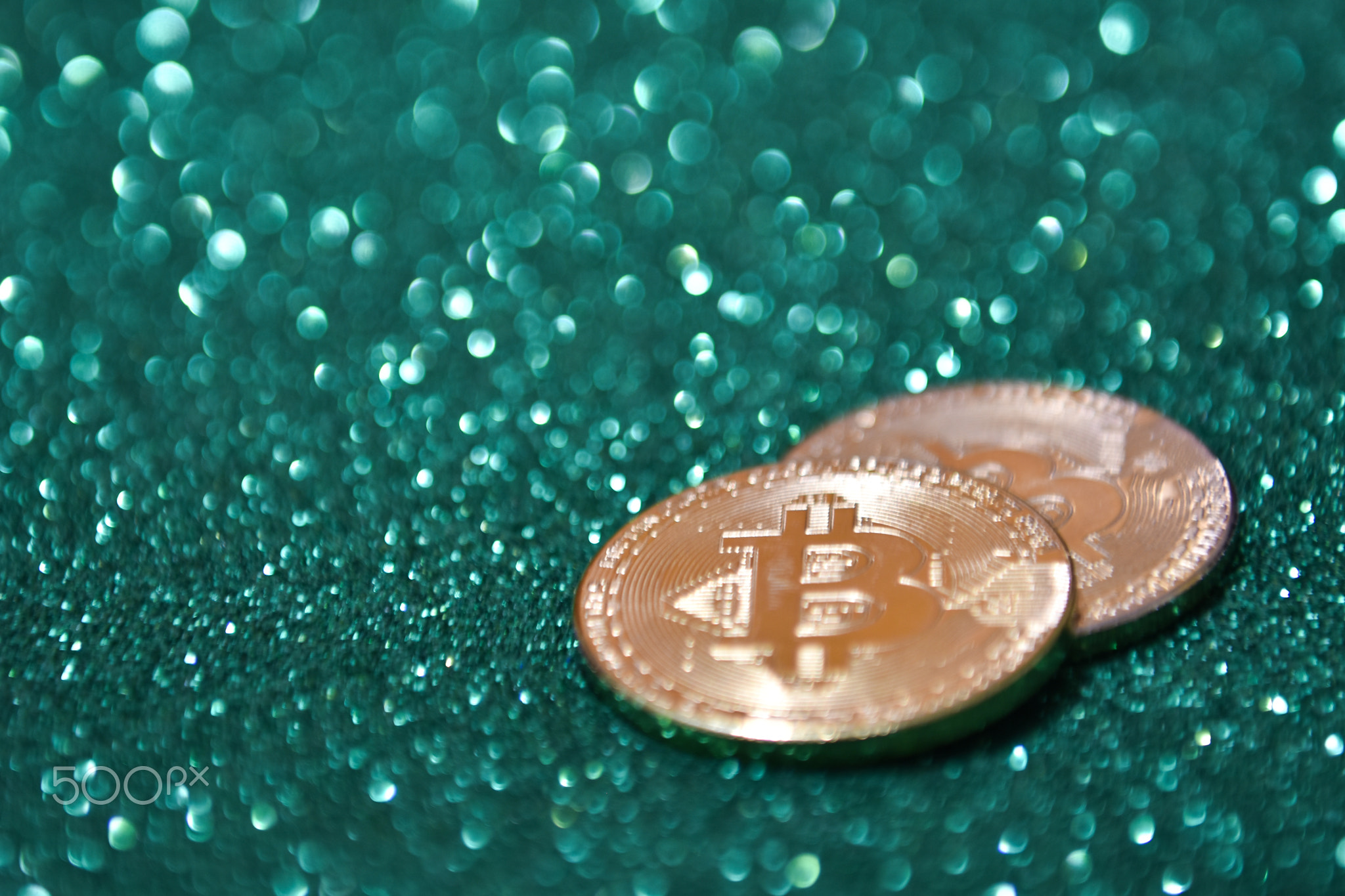 Golden bitcoin coin with glitter lights background