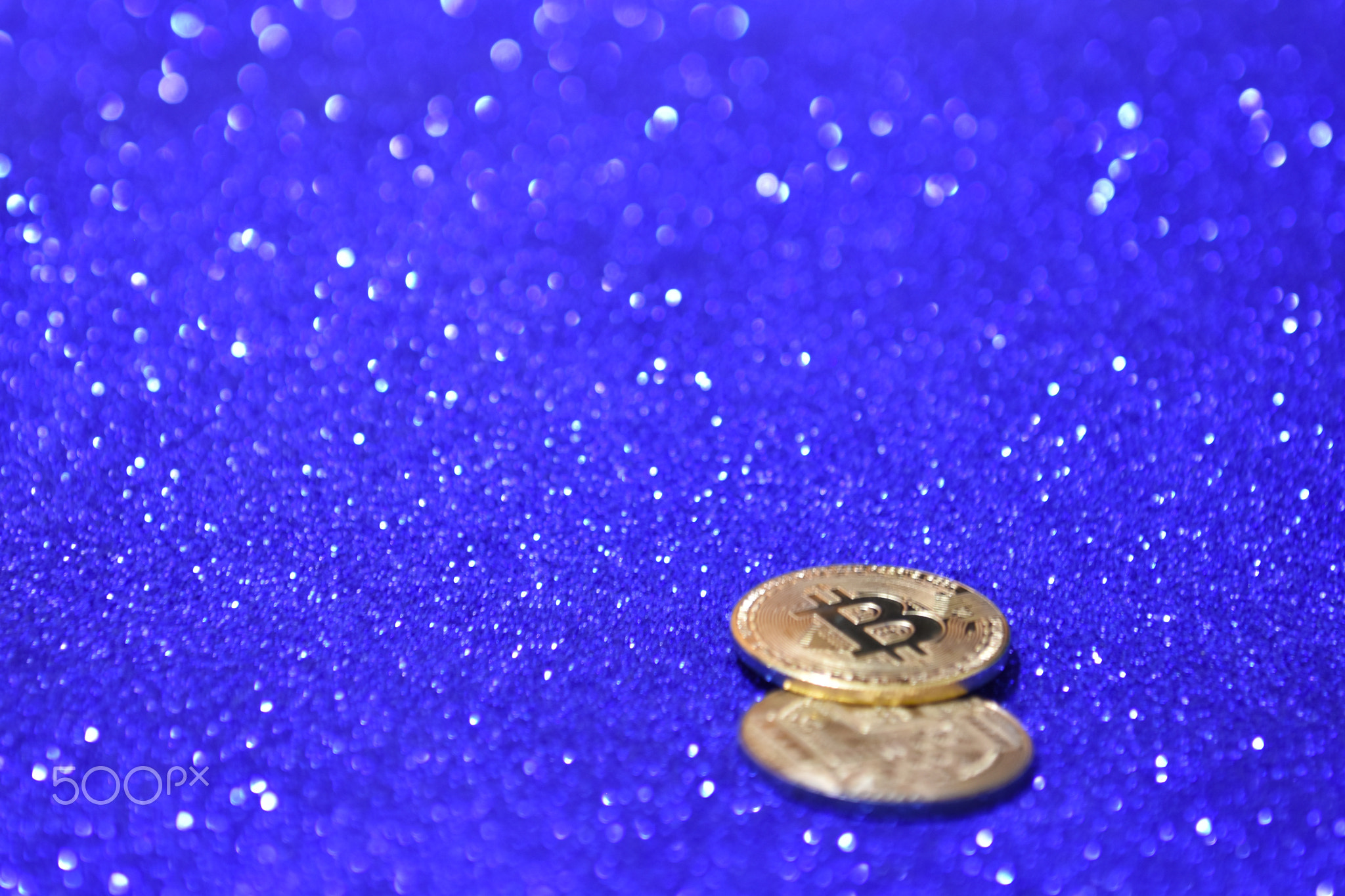 Golden bitcoin coin with glitter lights background