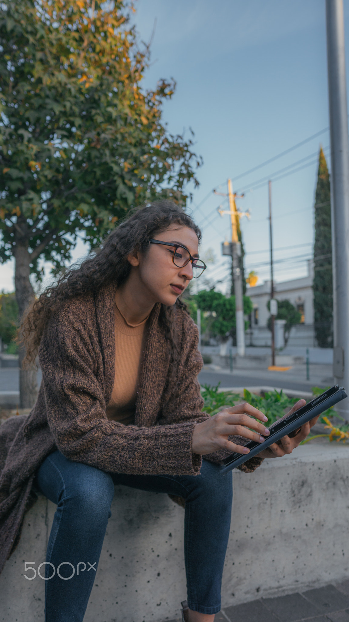 Woman on the street using her Ipad