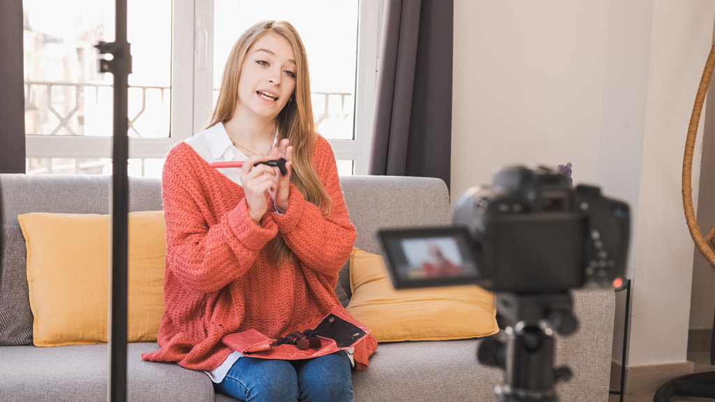 Young video blogger recording a makeup tutorial at home. Creating by Daniel Megias on 500px.com